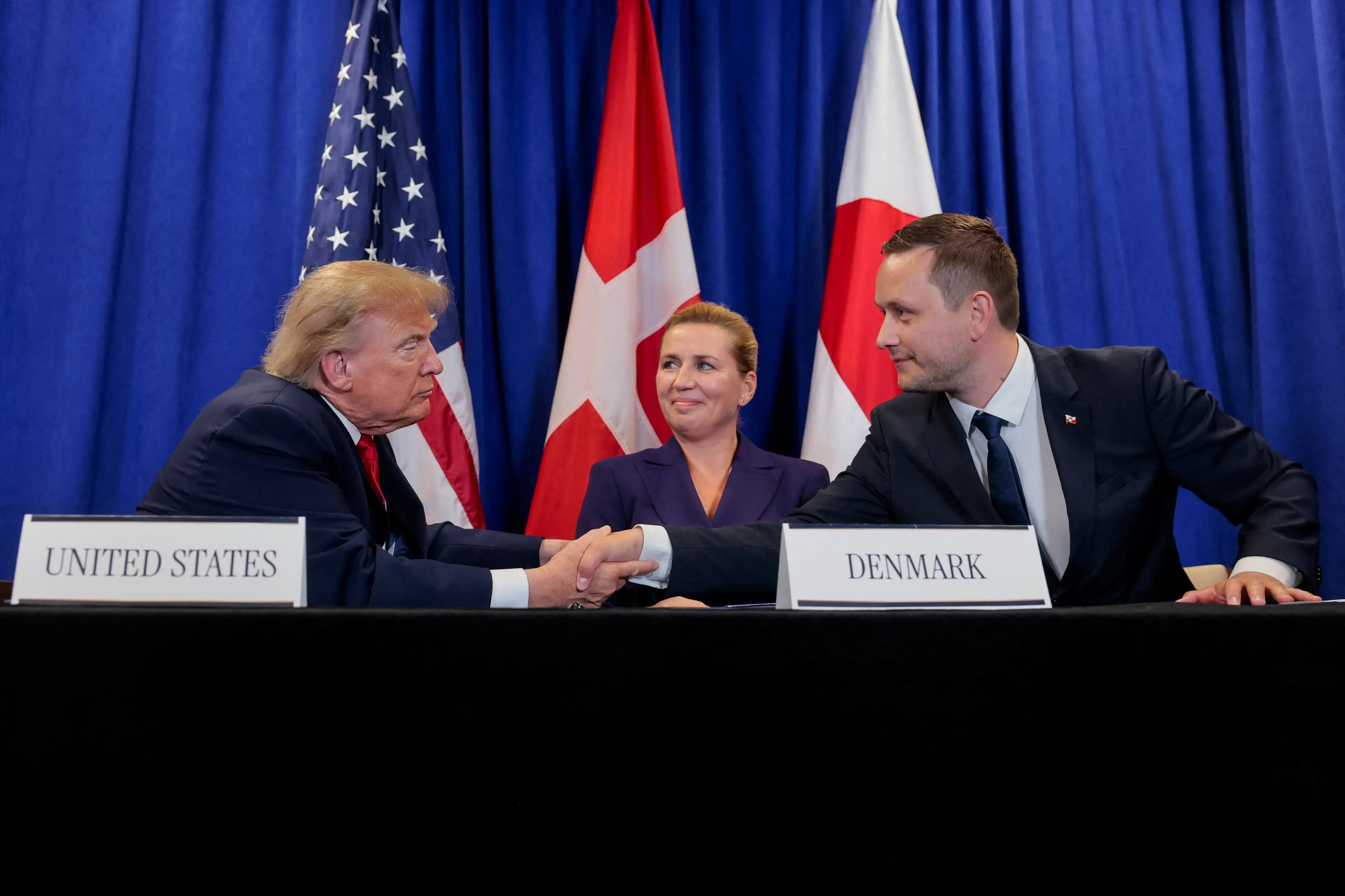 US President Donald Trump shakes hands with Greenland Prime Minister Jens-Frederik Nielsen as Danish Prime Minister Mette Frederiksen looks on in New York. Photo: Reuters