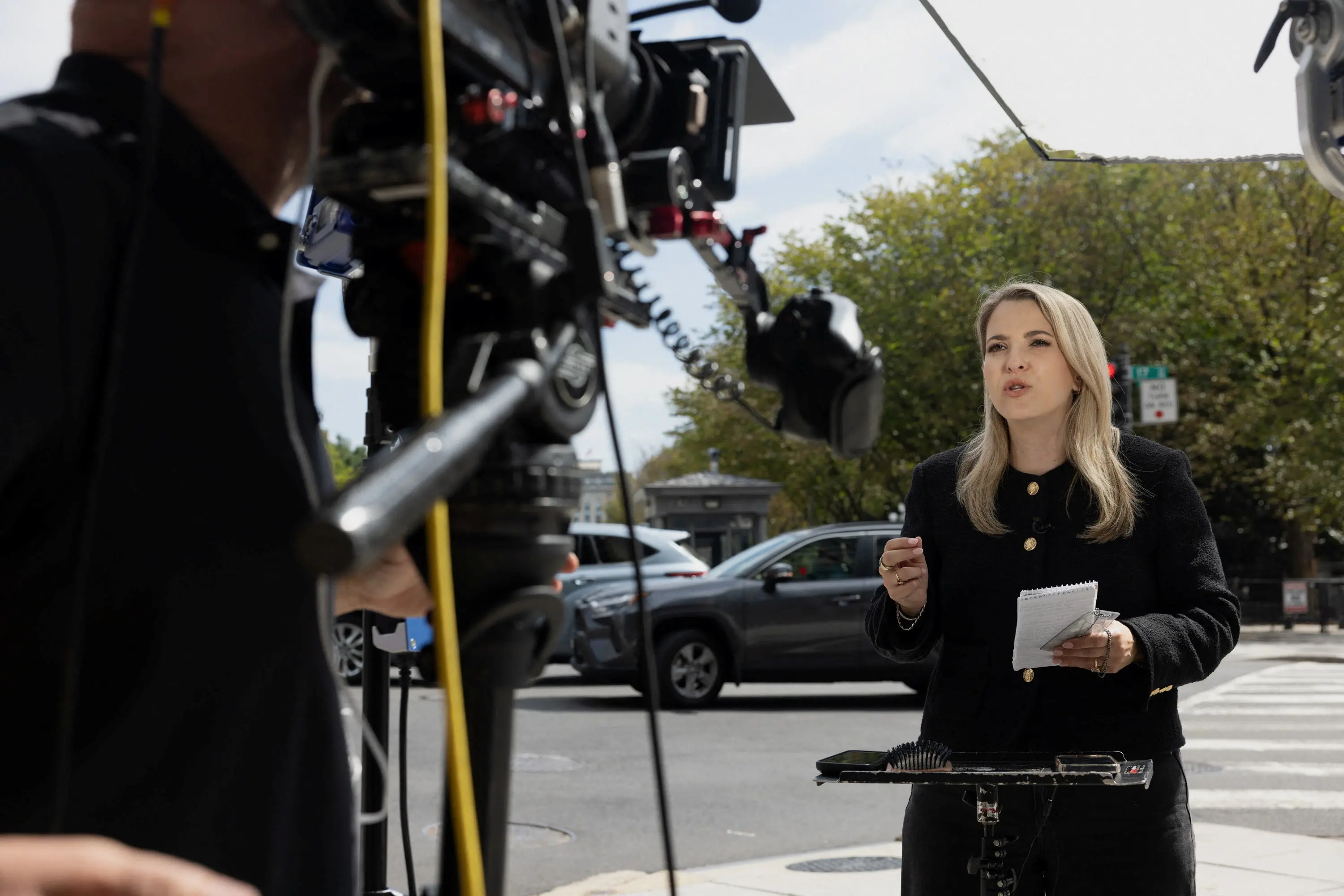 CNN correspondent Betsy Klein reports from the footpath outside the White House. Photo: Reuters