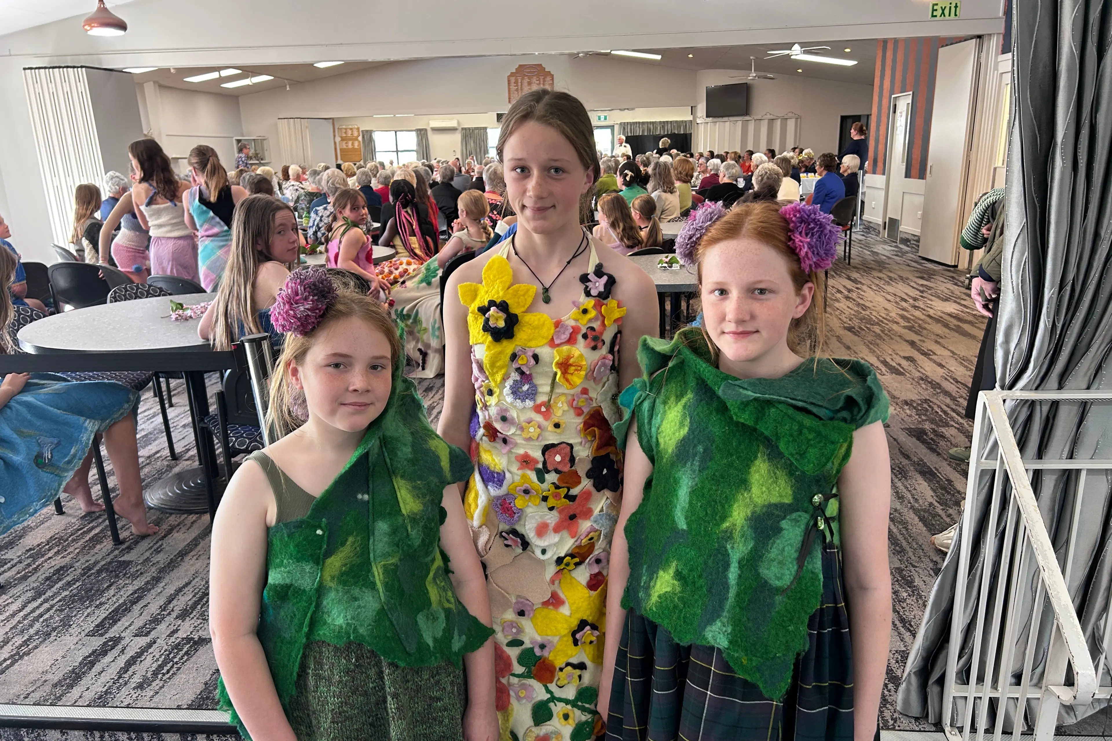 Clyde Primary School students paraded their WoolOn entries at the Alexandra Blossom Festival Senior Queen crowning on Tuesday. Showing their creations are (from left) Maddie Spencer, 11, Maddie Petersen and Charlotte Spencer, both 13. The Spencer sisters\\' creation \"Scottish Roots\" reflected their family history while Maddie Petersen\\'s entry took inspiration from Clyde\\'s floral displays. Photo: Julie Asher