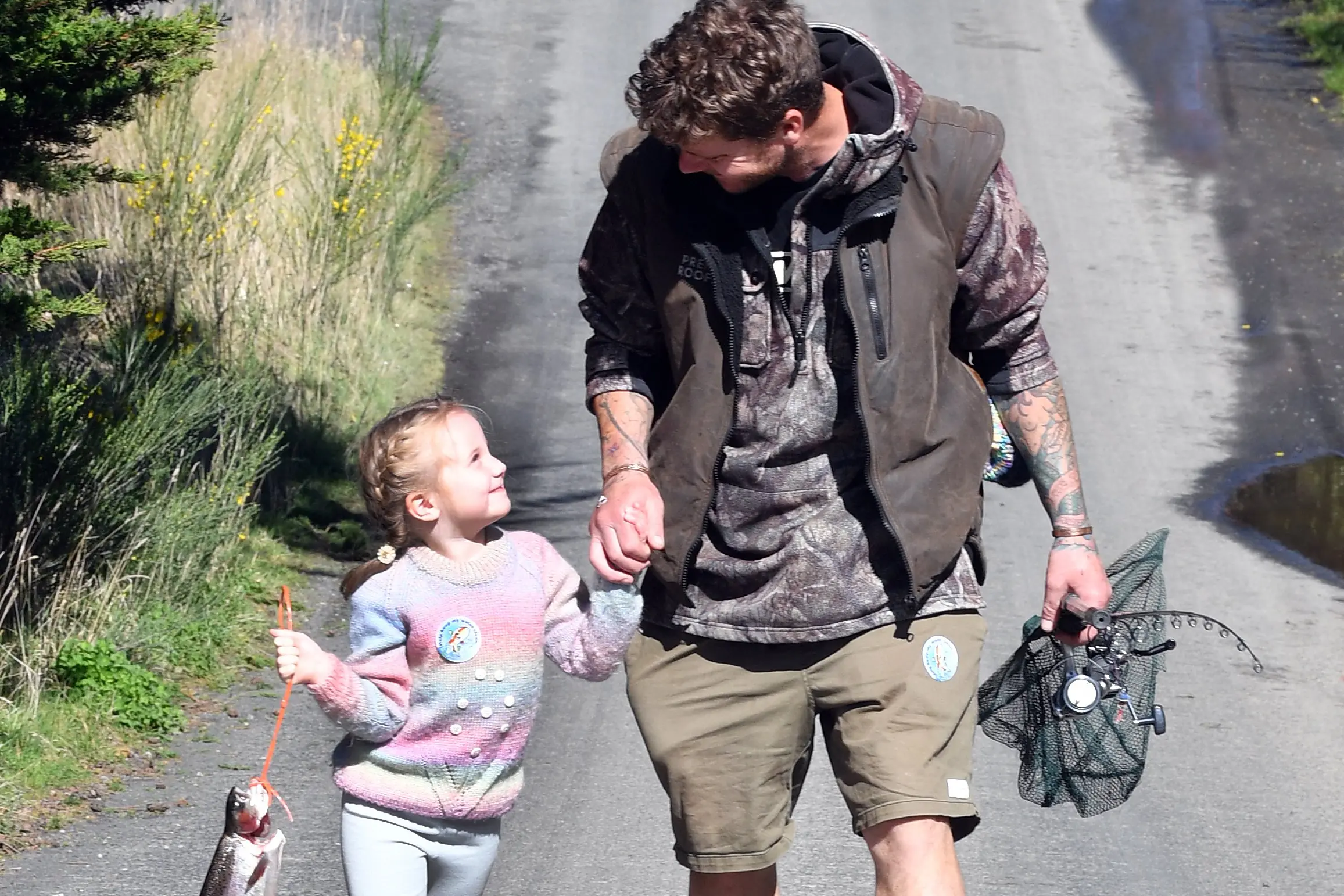 Father and daughter Joseph and Adeline van der Geest try to get their fishing stories straight before going home to tell Mum how they had caught dinner. Photo: Stephen Jaquiery
