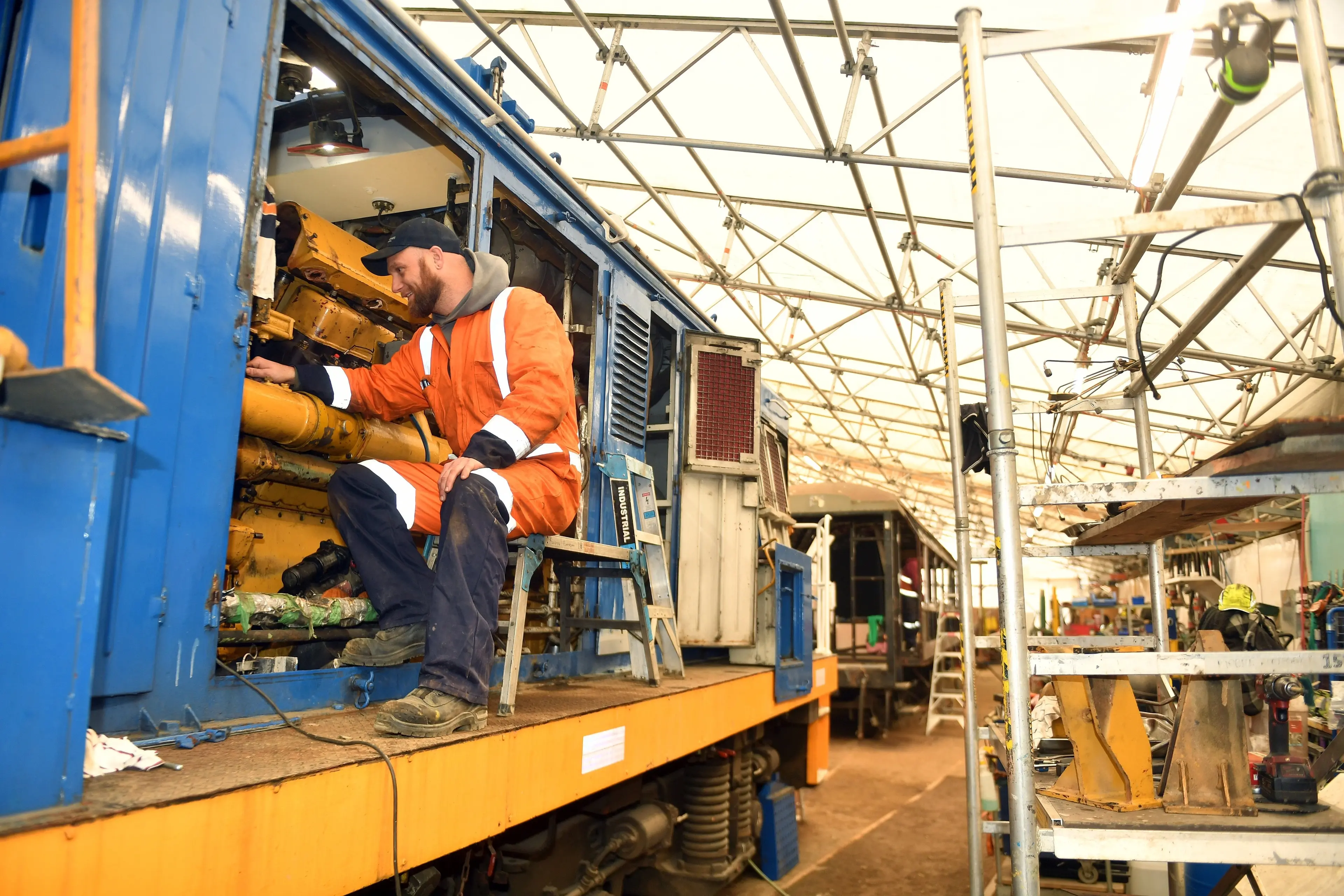 Dunedin Railways rolling stock mechanic, Joel Hendry, works on a locomotive under their tent like workshop structure. PHOTO STEPHEN JAQUIERY