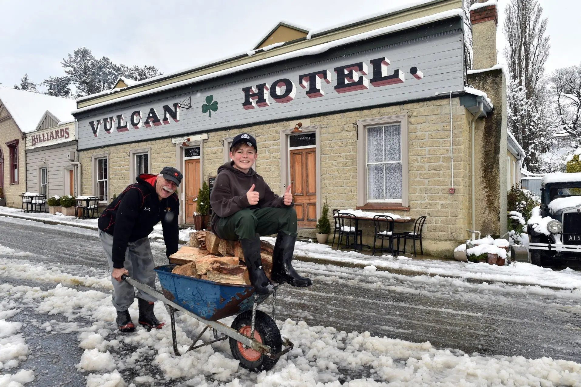 St Bathans visitor Arthur Boyt, 13, from Diamond Harbour, brings in firewood for the Vulcan Hotel with his grandad John Rains after a surprise snow dump. Photo: Gregor Richardson