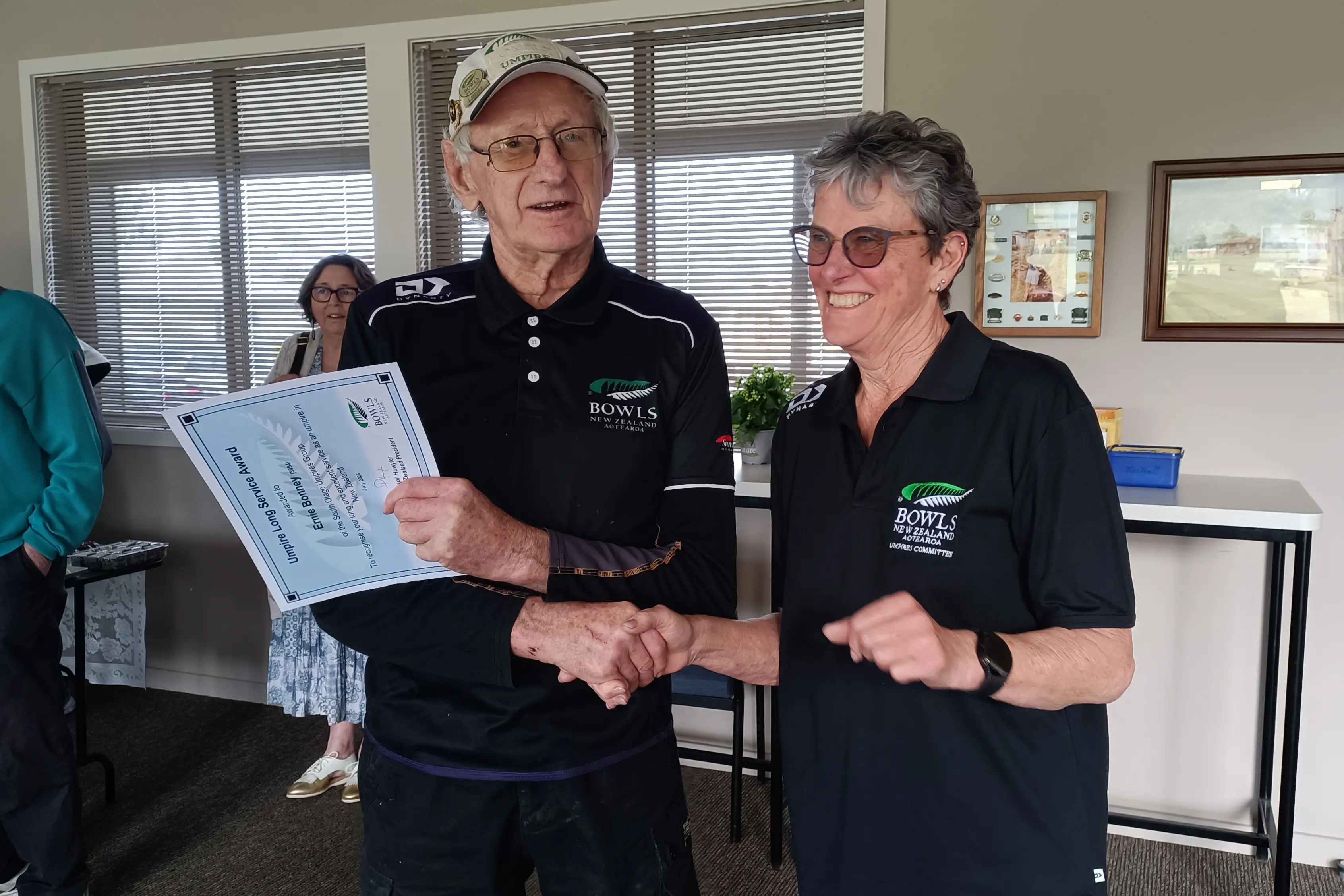 South Otago bowling umpire Ernie Bonney receives a certificate acknowledging his 31 years of service from Bowls NZ umpires committee member and recently named Umpire of the Year Pauline Seaton, during the centre\\'s opening day at Balclutha Bowling Club on Saturday. Photo: Supplied