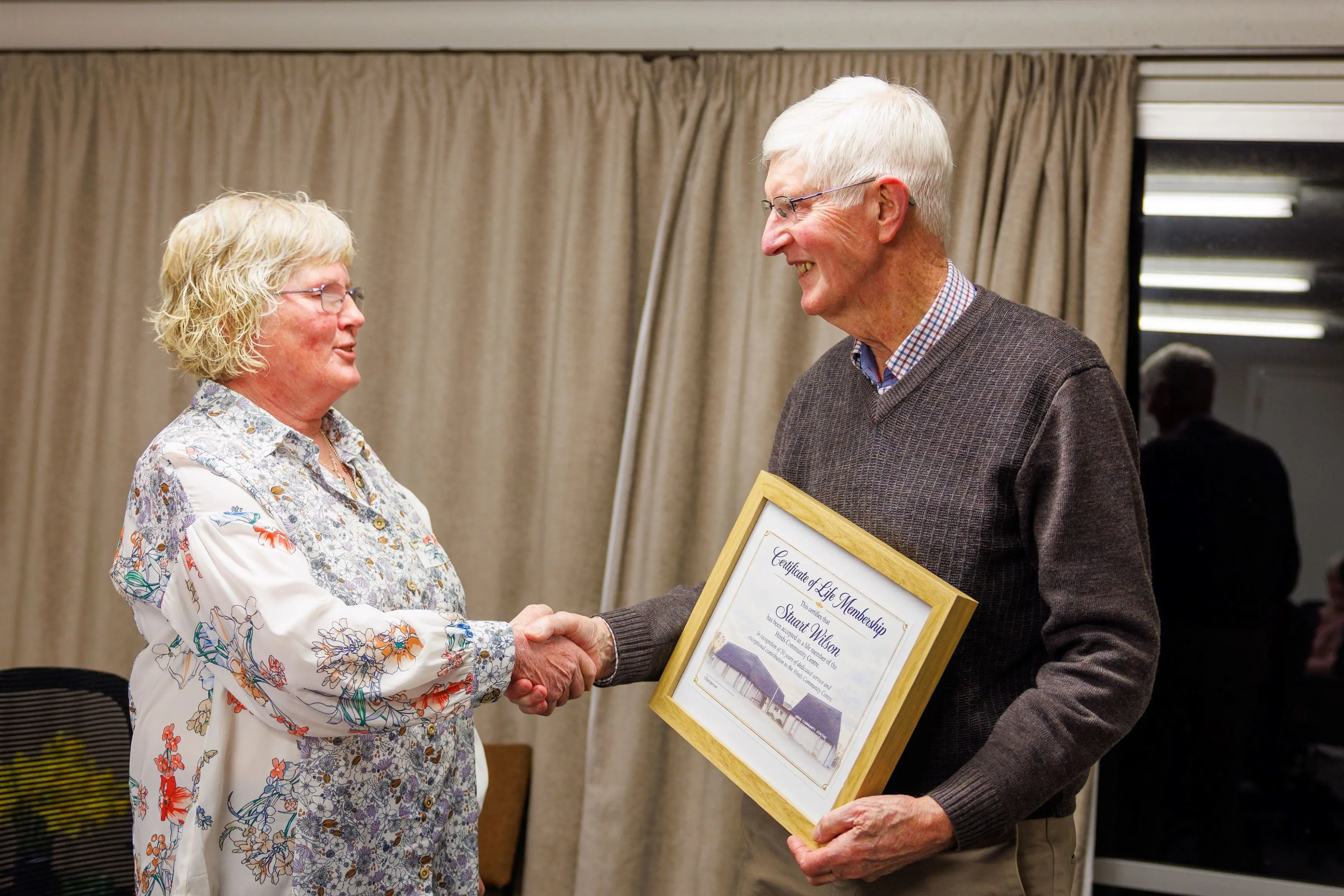 Hinds Community Centre chair Fiona Keir presents stalwart Stuart Wilson with a life membership of the centre. Photo: Supplied