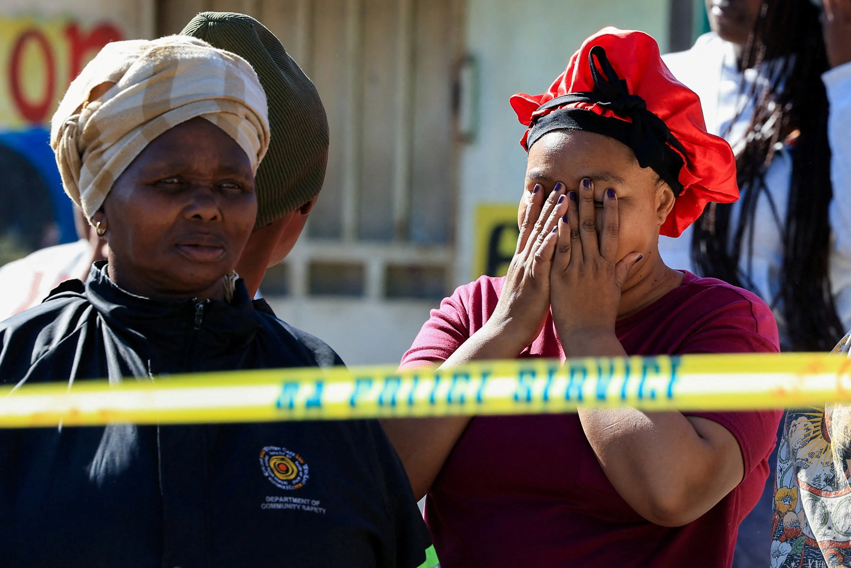 People gathered at the site of a shooting in Lwandle, on the outskirts of Cape Town. Photo: Reuters