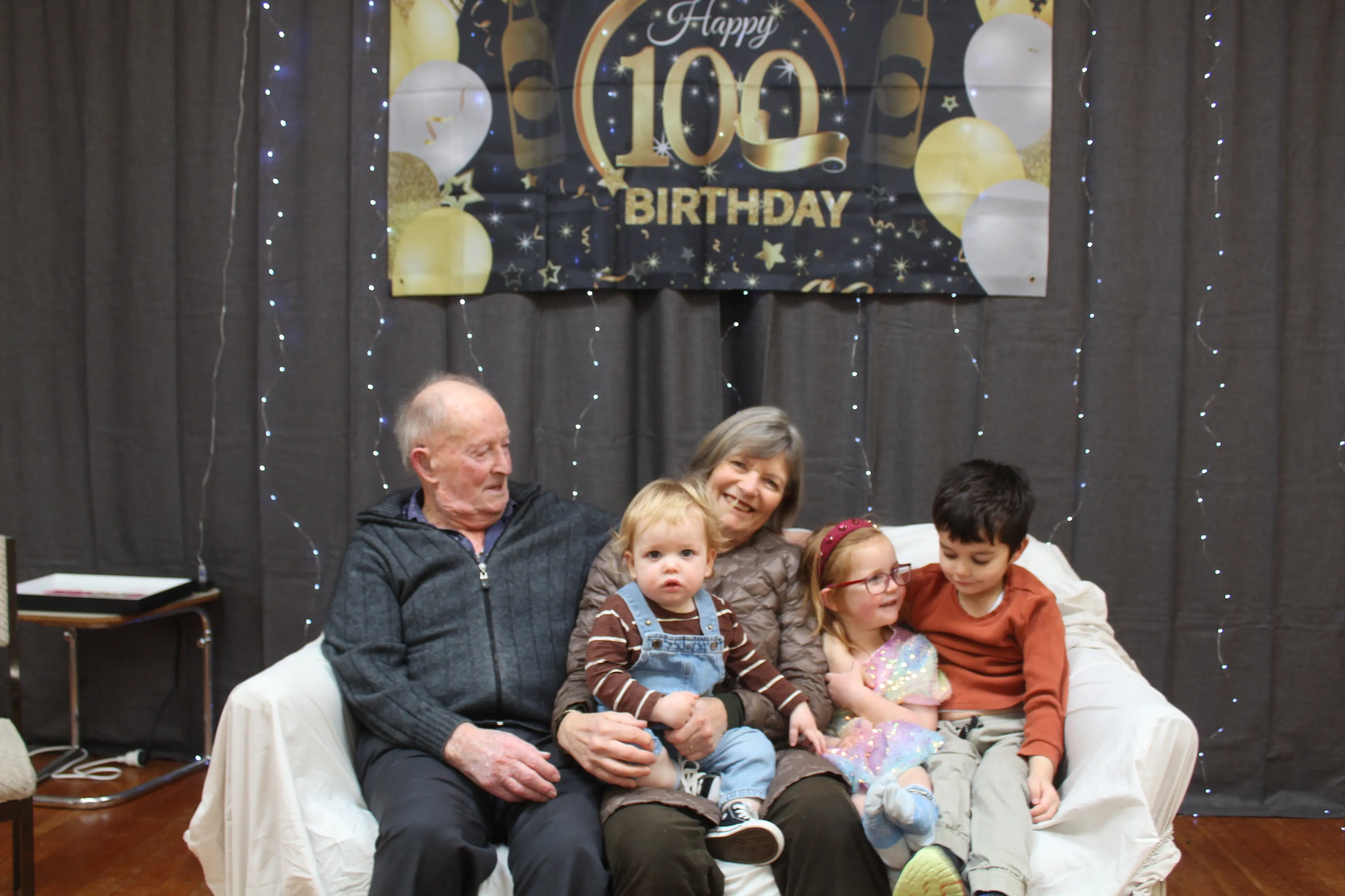 The celebration of the 100-year milestone was held at the Invercargill Blind and Low Vision Centre, enjoying the festivities were (from left) Brian Pears, Sharon Faul, Jack Faul, 17 months, Lucy Faul, 3, and Harry Faul, 5. Photo: Tayler Mutton