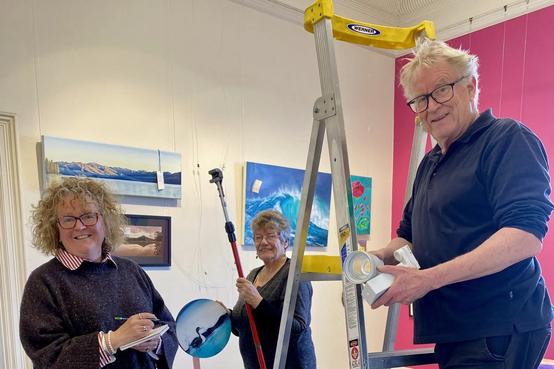 The exhibition team for the Otago Art Society\\'s Ryman Spring Exhibition \\u201CNew Beginnings\\u201D, (from left) exhibition judge and artist Denise McMahon, exhibition curator and artist Jenny Longstaff, and artist Raimo Kuparinen, work on setting up the exhibition, which is open to the public from this Saturday, October 3. Photo: Supplied