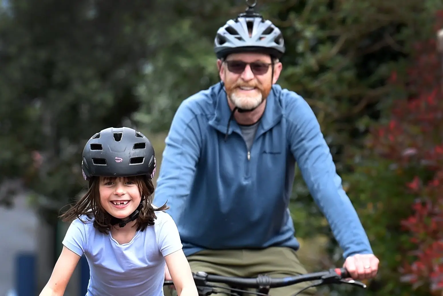 Spokes Dunedin secretary Nathan Kershaw biking on the footpath with his daughter Beatrice Kershaw, 9, after new laws around parent-child cycling on footpaths came into force. Photo: Peter McIntosh