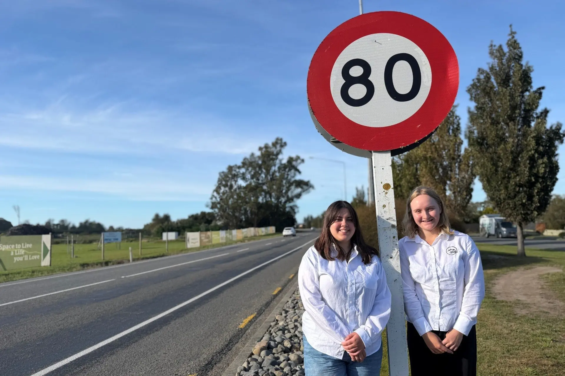 Slow down . . . Hurunui Youth Council members Lexi Thomson-Hall (left) and Zinnea Cohen were among those who called the speed limit to reduced on State Highway south of Amberley. Photo: Supplied by Hurunui District Council