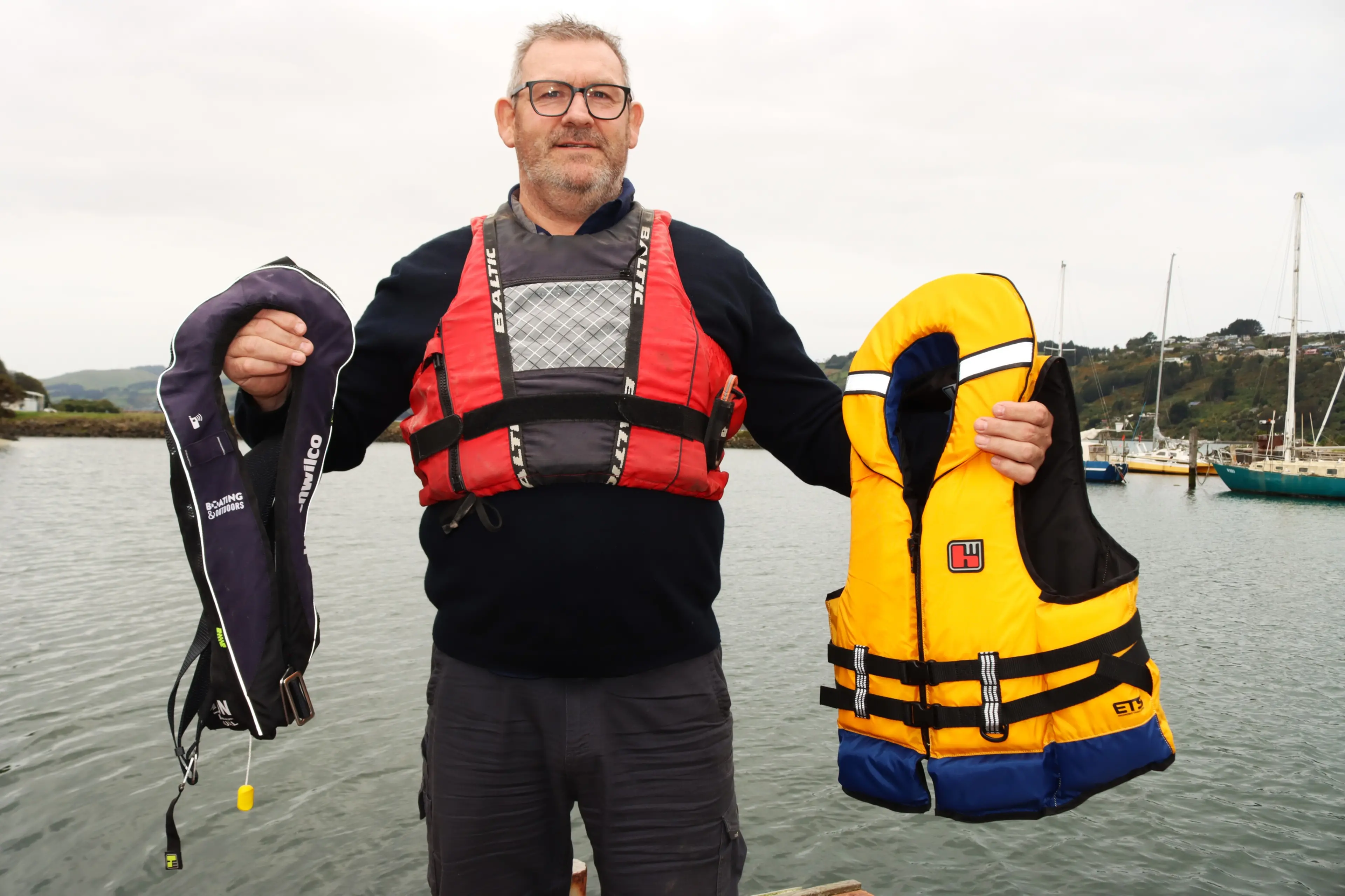 Otago Regional Council harbourmaster Steve Rushbrook shows examples of lifejackets that all need to wear on the water. Photo: Sam Henderson