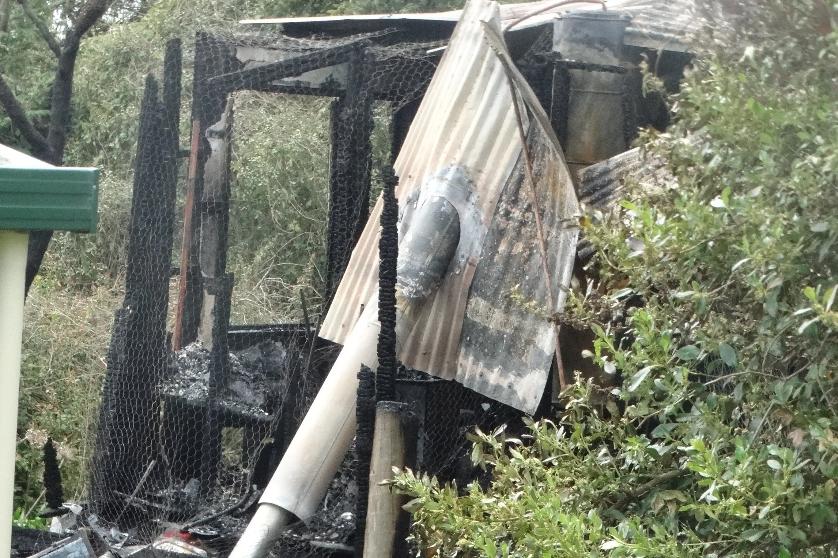 Charred remains of the Hampden house on Saturday. Photo: Nic Duff