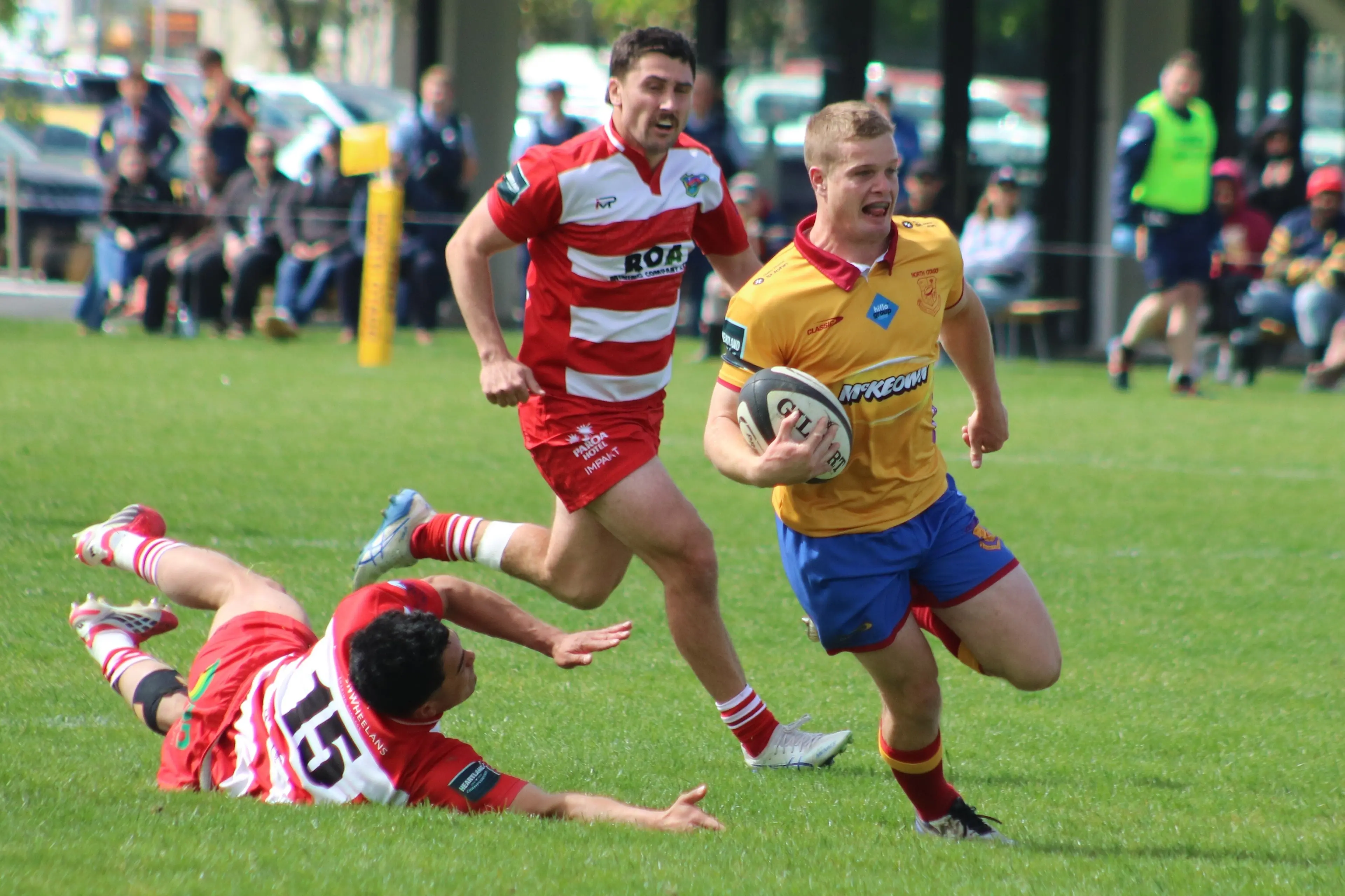 North Otago winger Ben McCarthy darts away to score leaving West Coast backs Jaime Garland (left) and Tom Ziolo in his dust. Photo: Kayla Hodge