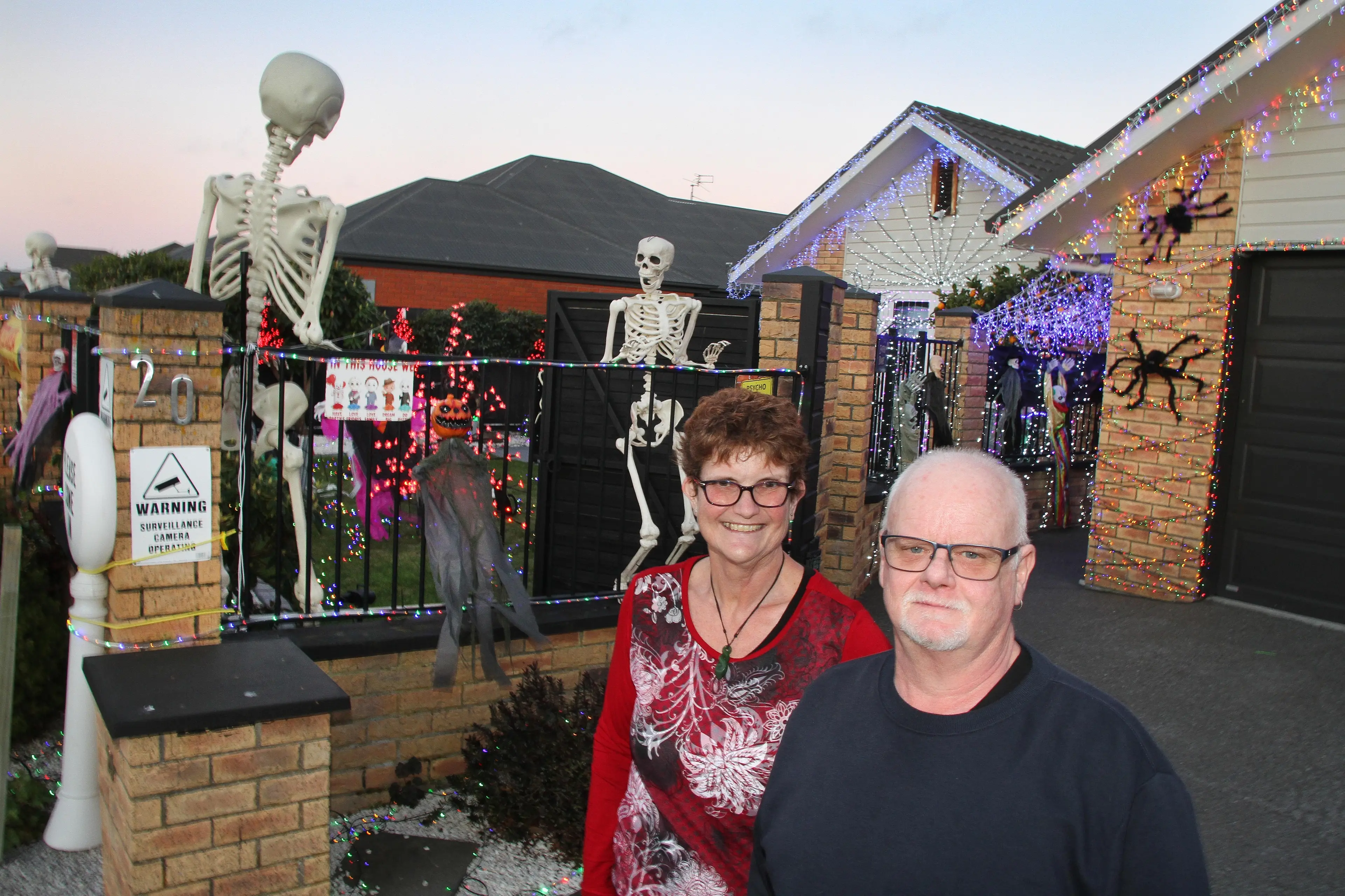 Our Halloween display . . . Susan and Martin Paisey stand outside their Fergus Street, Kaiapoi, property with its colourful Halloween display for all to enjoy. Photo: John Cosgrove