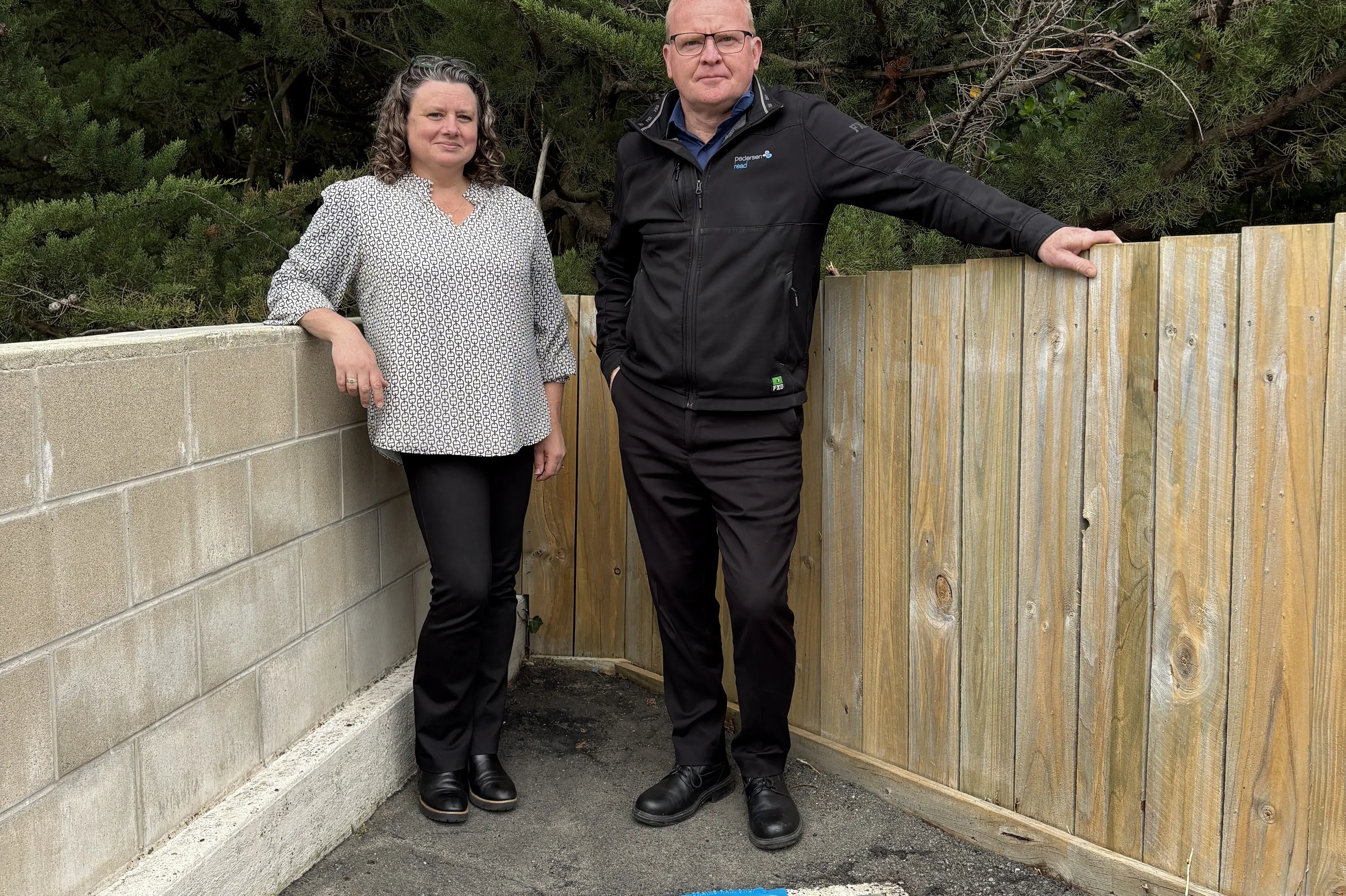 Kaikorai Valley property owners Julie-Ann Ross (left), of Design Arc, and Tony Ross, of Pederson Read, are pictured outside Kai Mocha Cafe with the drain they plan to adopt. Photo: Supplied