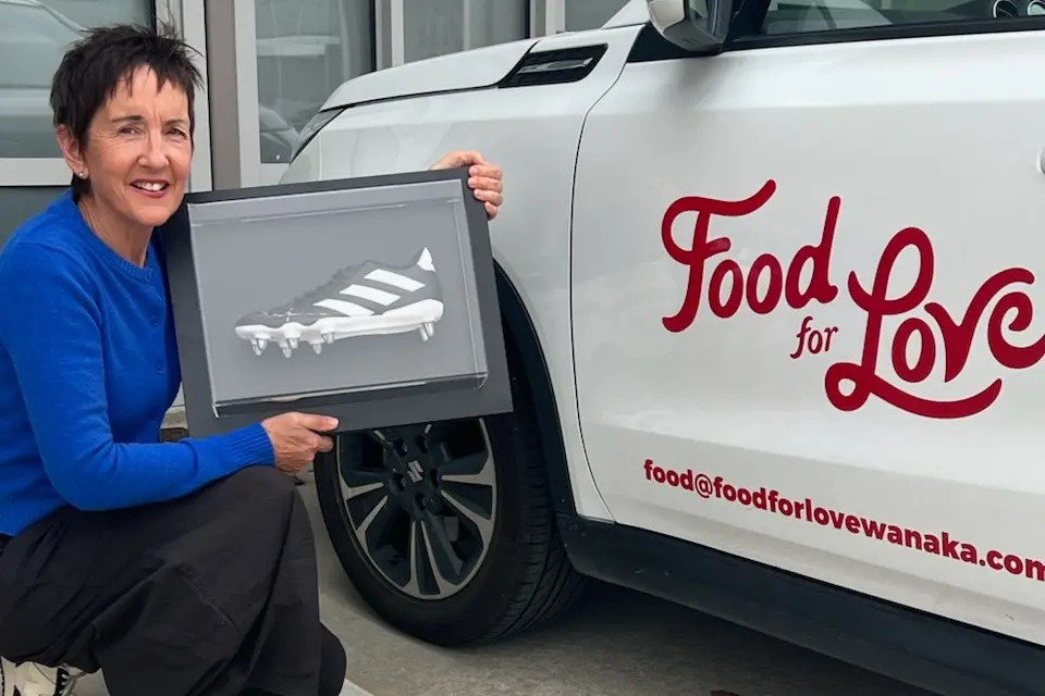 Food For Love general manager Sue Clarke with the signed Dan Carter boot to be auctioned off at this year\\'s gala. Photo: Supplied