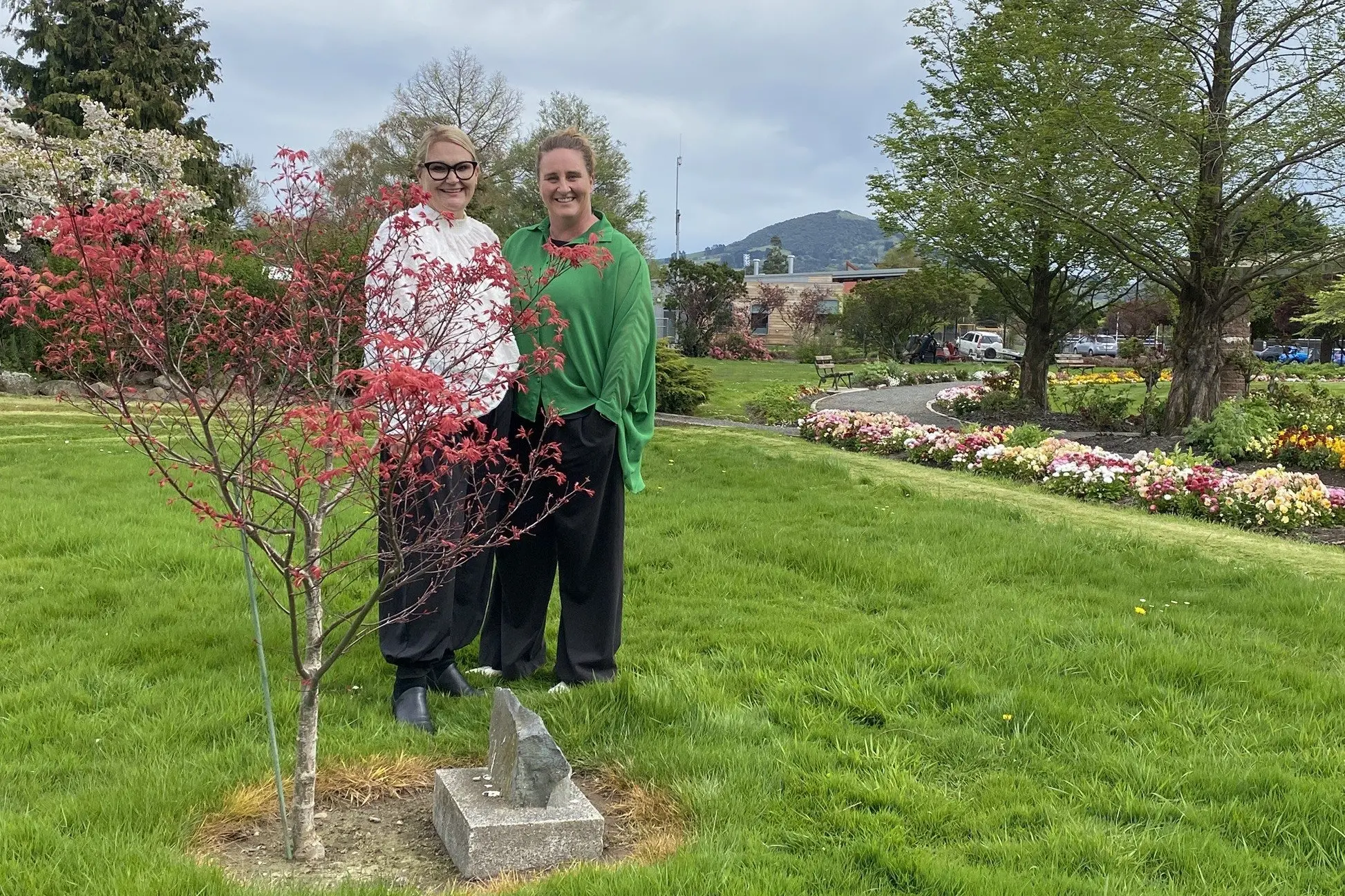 A Star is Born chairwoman Julie Moyle, left, and founding board member Justine Weatherall stand with the memorial tree for lost babies in the Green Island Memorial Gardens ahead of the charitable trust\\'s 10th birthday celebrations this month. Photo: Brenda Harwood