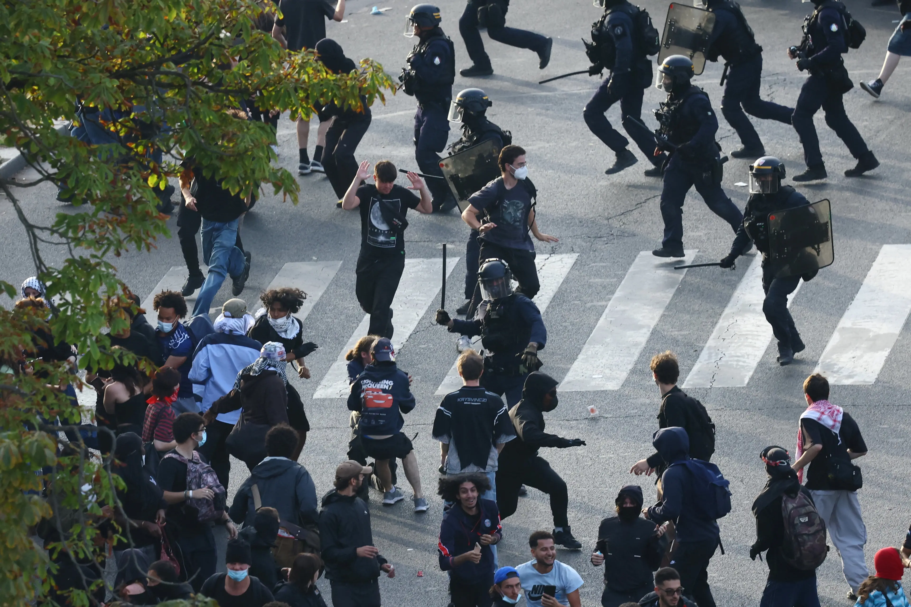 Riot police charge protesters amid clashes at Place de la Nation in Paris. Photo: Reuters