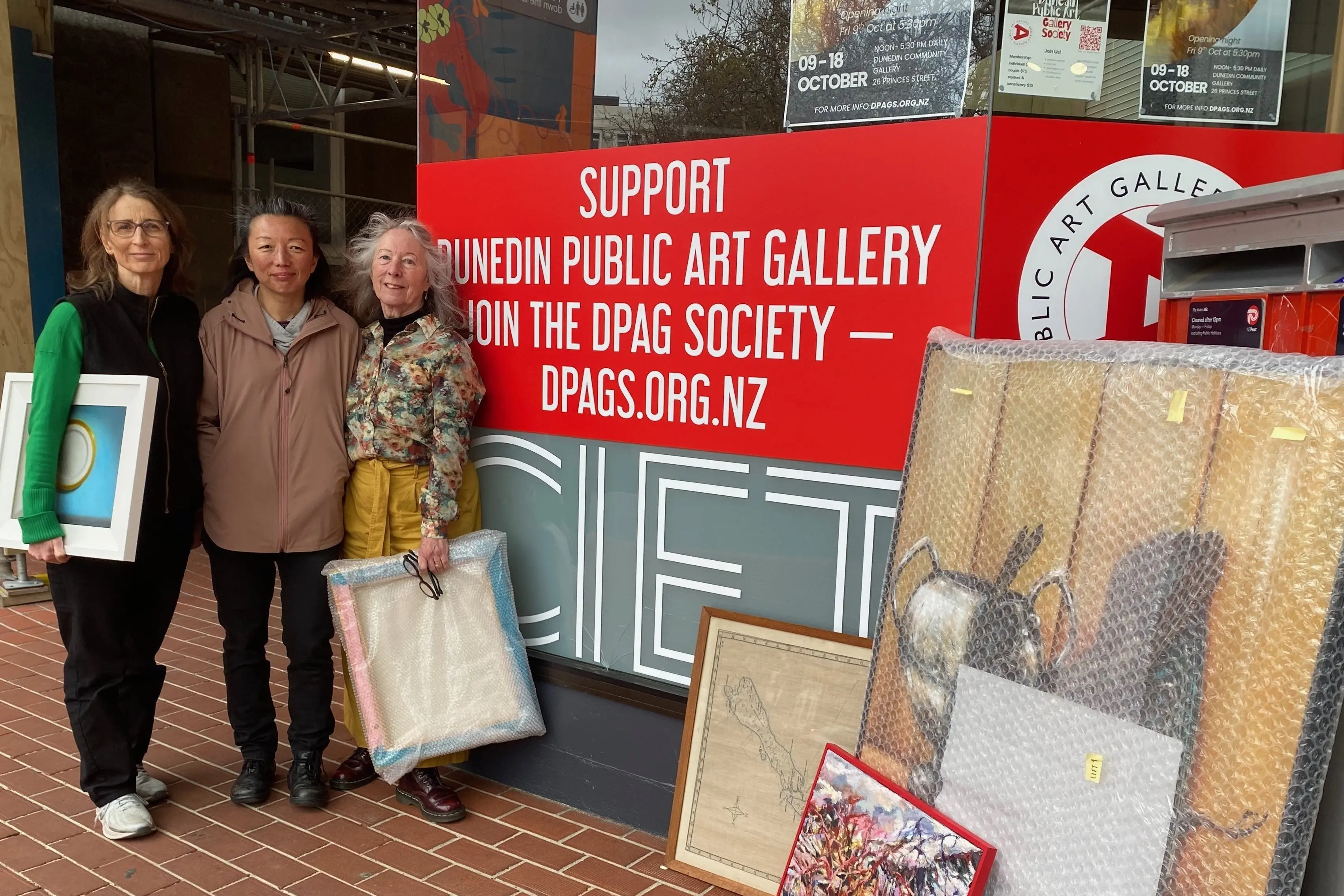 Dunedin Public Art Gallery Society members (from left) Kirsten McAuley, Siau-Jiun Lim and Linda Cook prepare for the Members\\' Exhibition, opening this Friday night. Photo: Supplied