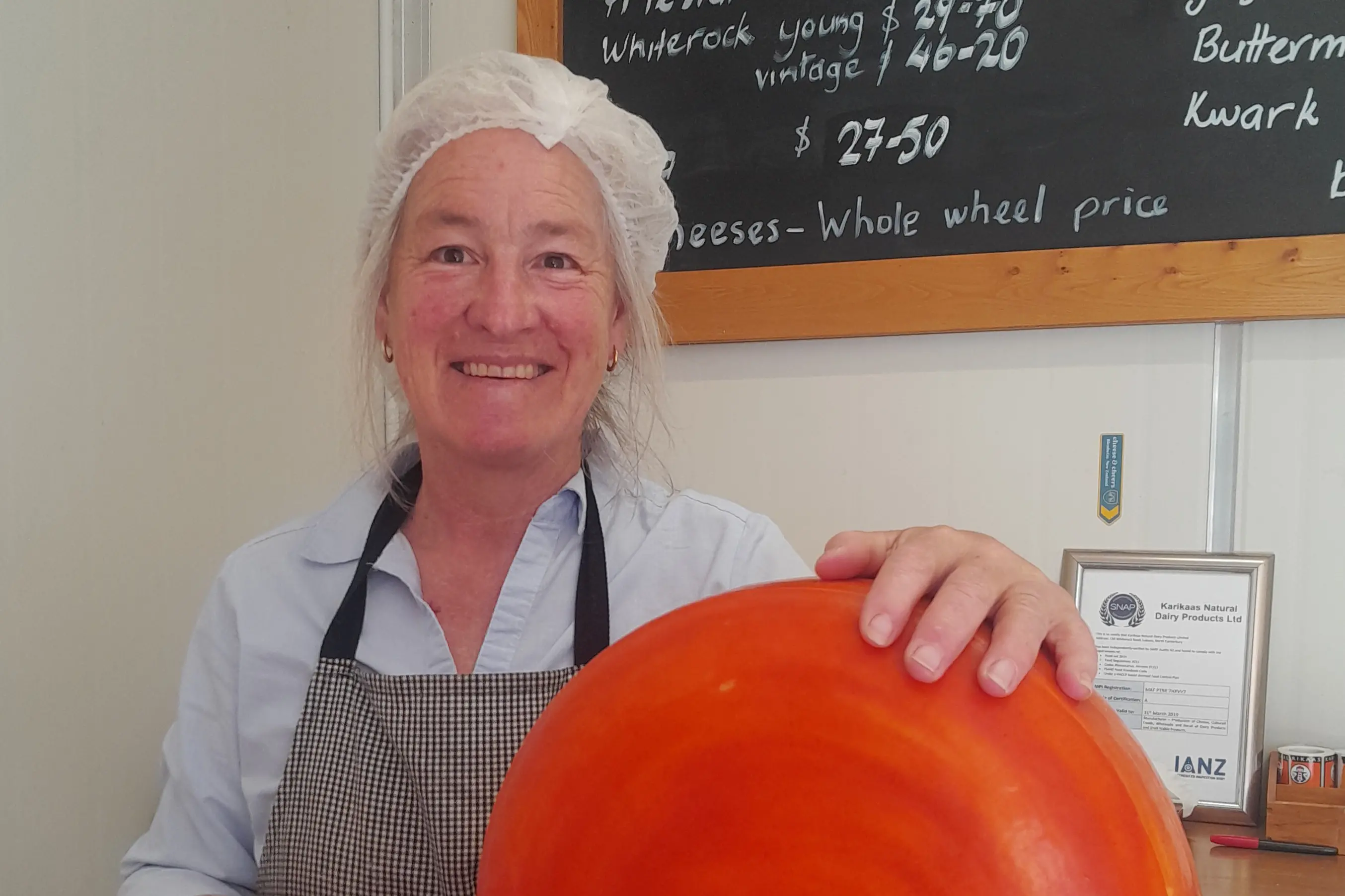 Makerikeri . . . Diana Hawkins, with a  new red/orange cheese made by Karikaas in Loburn, and named after the local stream, in the apple growing belt of Loburn.Photo: Supplied