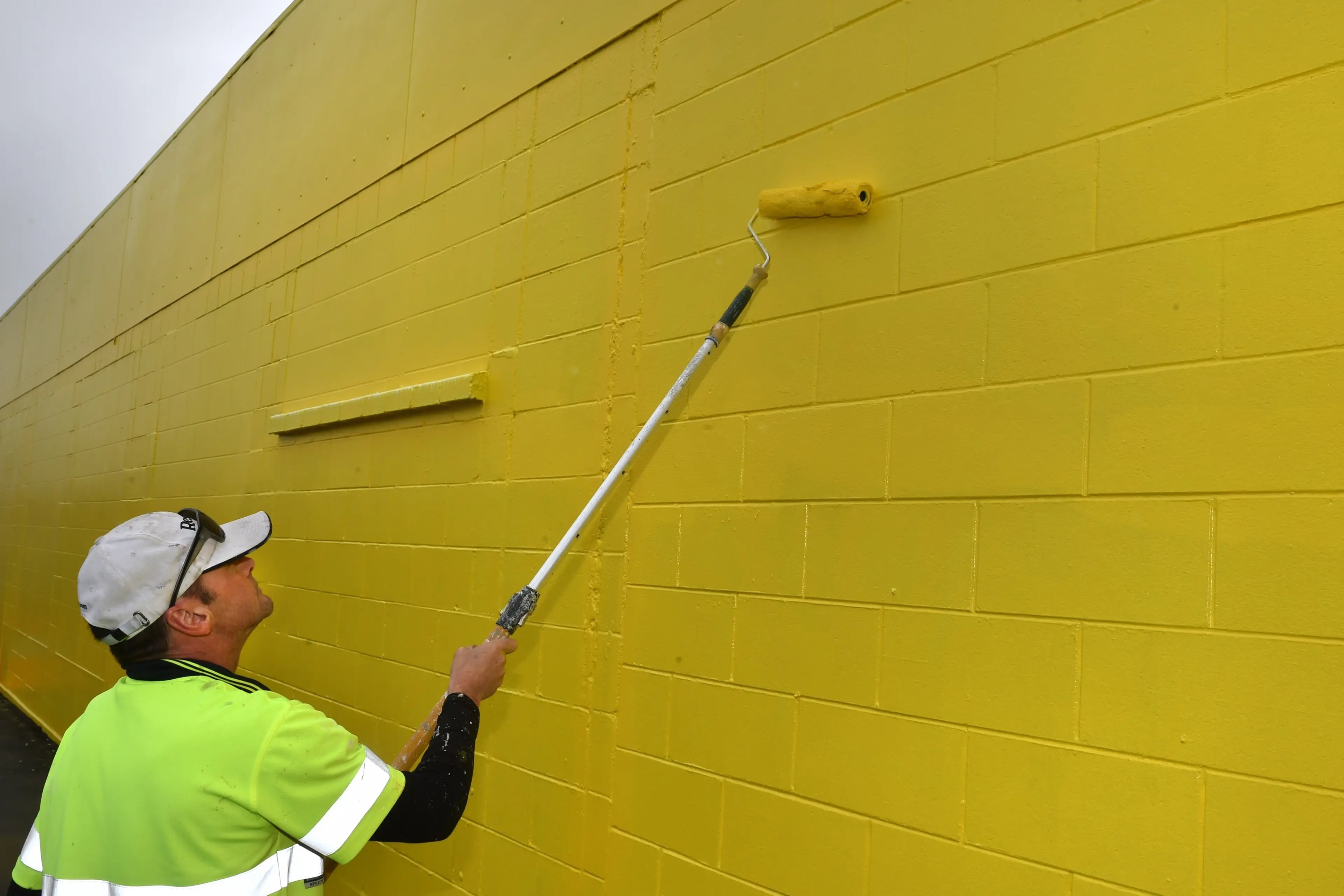 Wrens painter Damian Bouzaid puts the finishing touches to a new paint job on the outside of the former Torpedo 7 building in Andersons Bay Rd. Photo: Gregor Richardson