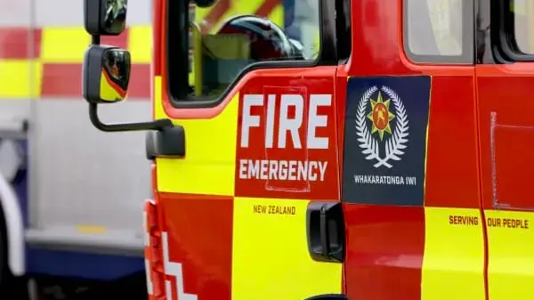People cut from car after colliding with truck carrying house