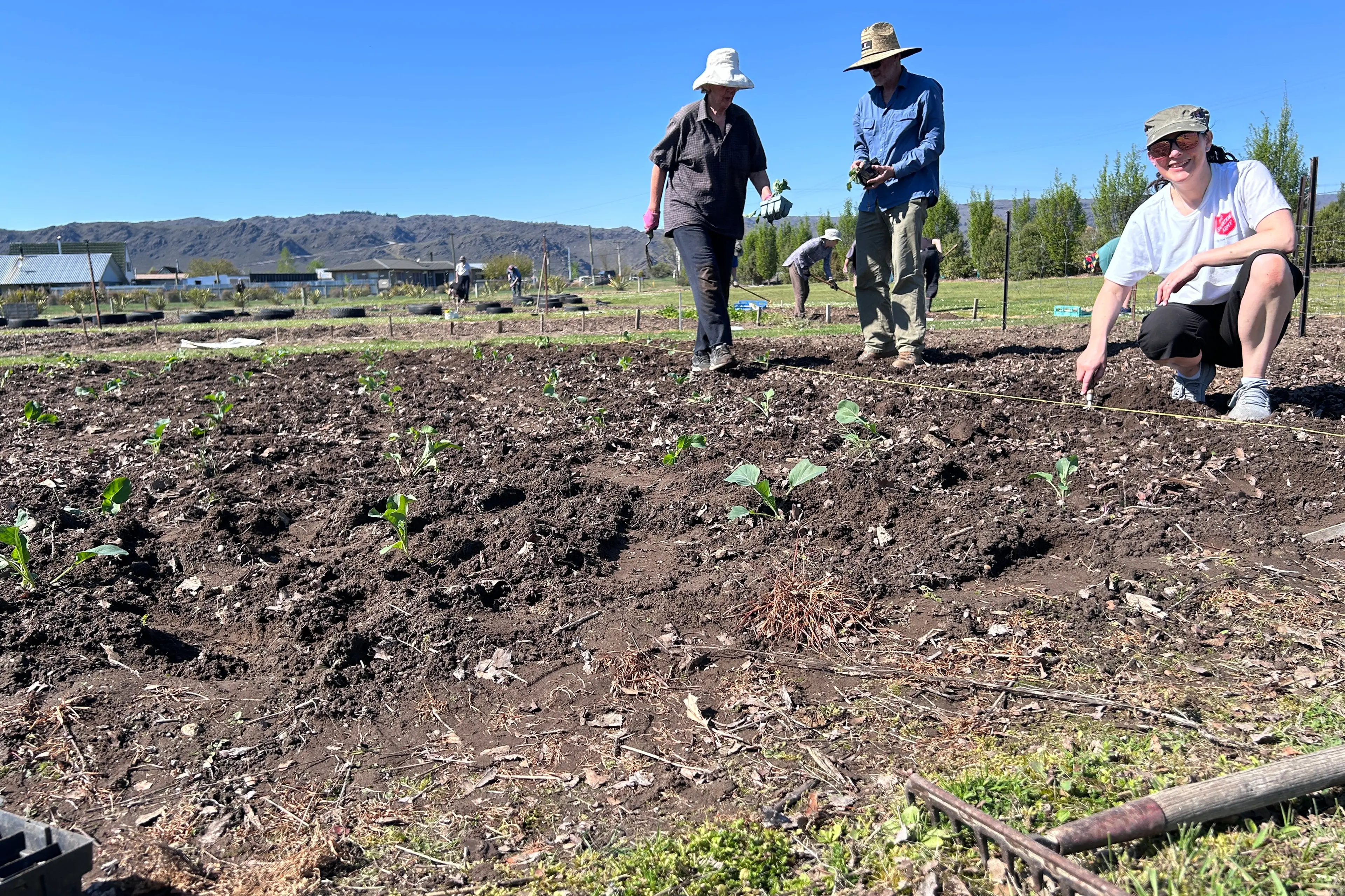Planting at Eden Community Garden opening day in Alexandra are (from left) Elaine Thompson, Rhys Jenkins and Salvation Army Captain Char Whybrow. A wide range of vegetables were planted in eight beds under the supervision of garden manager Brian Seymour. The produce would be donated to the food bank when it was harvested. Photo: Julie Asher