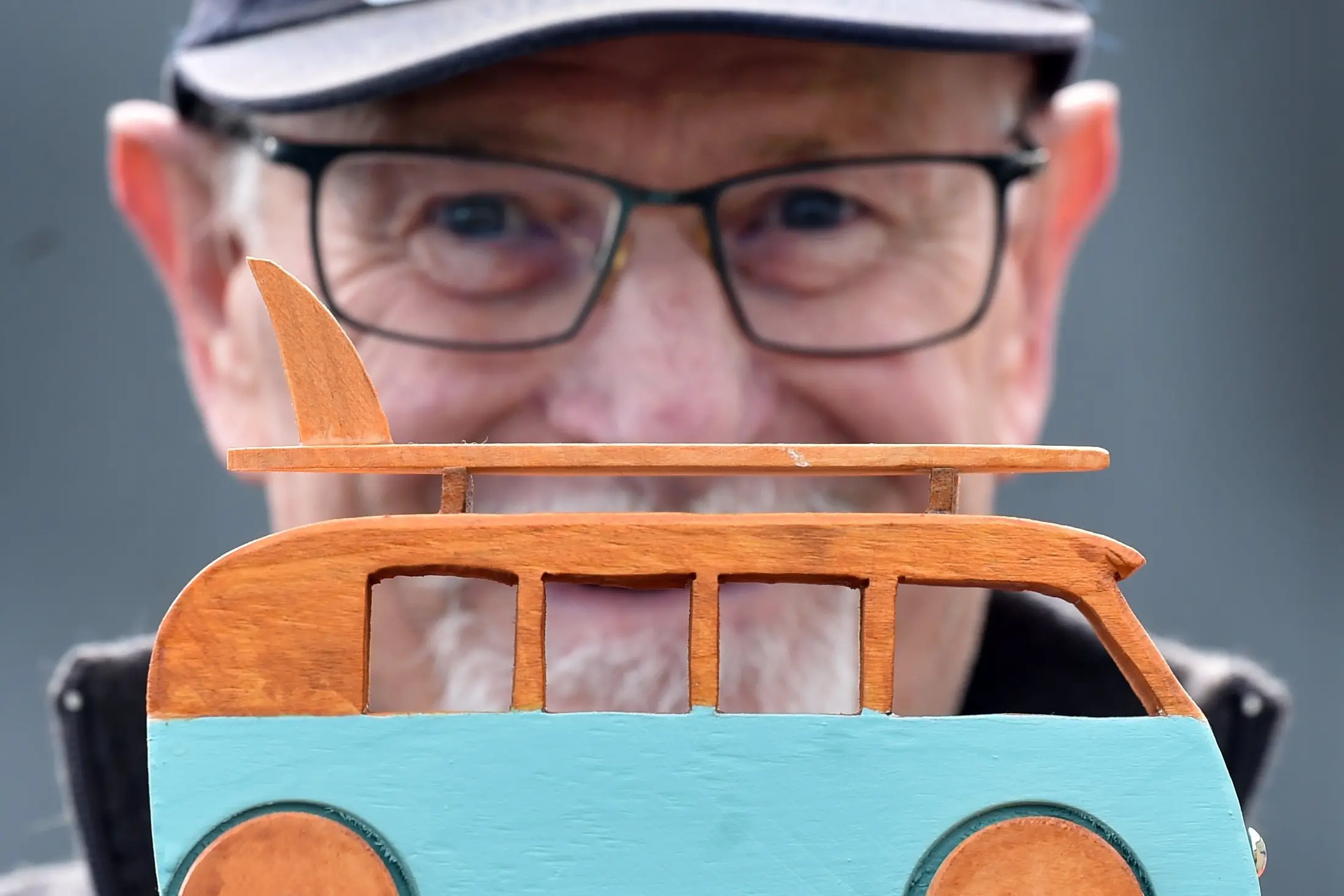 Gary Loe, of Mosgiel, displays a wooden Combi van he made \\u2014 one of his many toys for sale during the Taieri Blokes Shed open day in Mosgiel on Saturday. Photo: Peter McIntosh