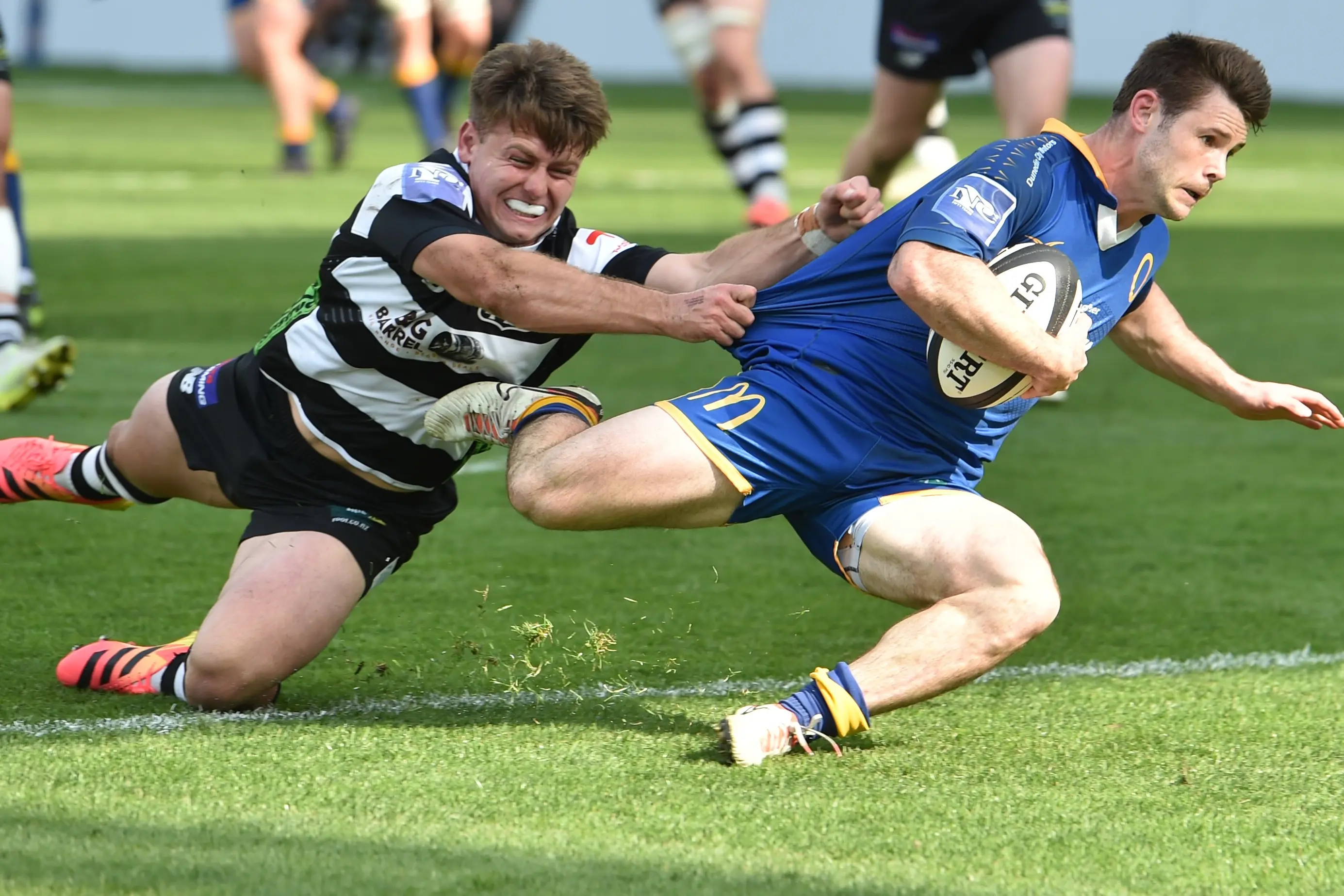 Otago halfback Kieran McClea goes in for a try despite the effort of Hawke\\'s Bay first five Harry Godfrey during an NPC quarterfinal in Dunedin on Saturday afternoon. Photo: Peter McIntosh