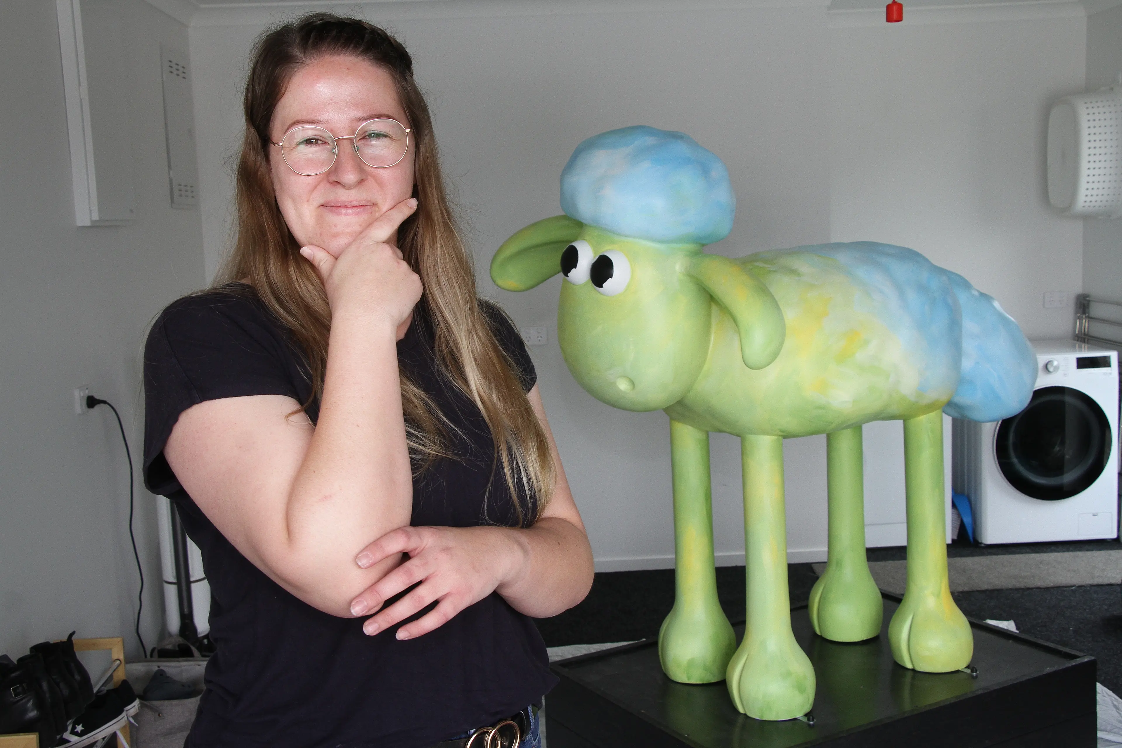Hmm, what colour shall I use? . . North Canterbury artist Leah Ingram ponders her next move as she begins to decorate a kiwi version of Shaun the Sheep, as part of a large-scale art installation planned for Christchurch next year. Photo: John Cosgrove