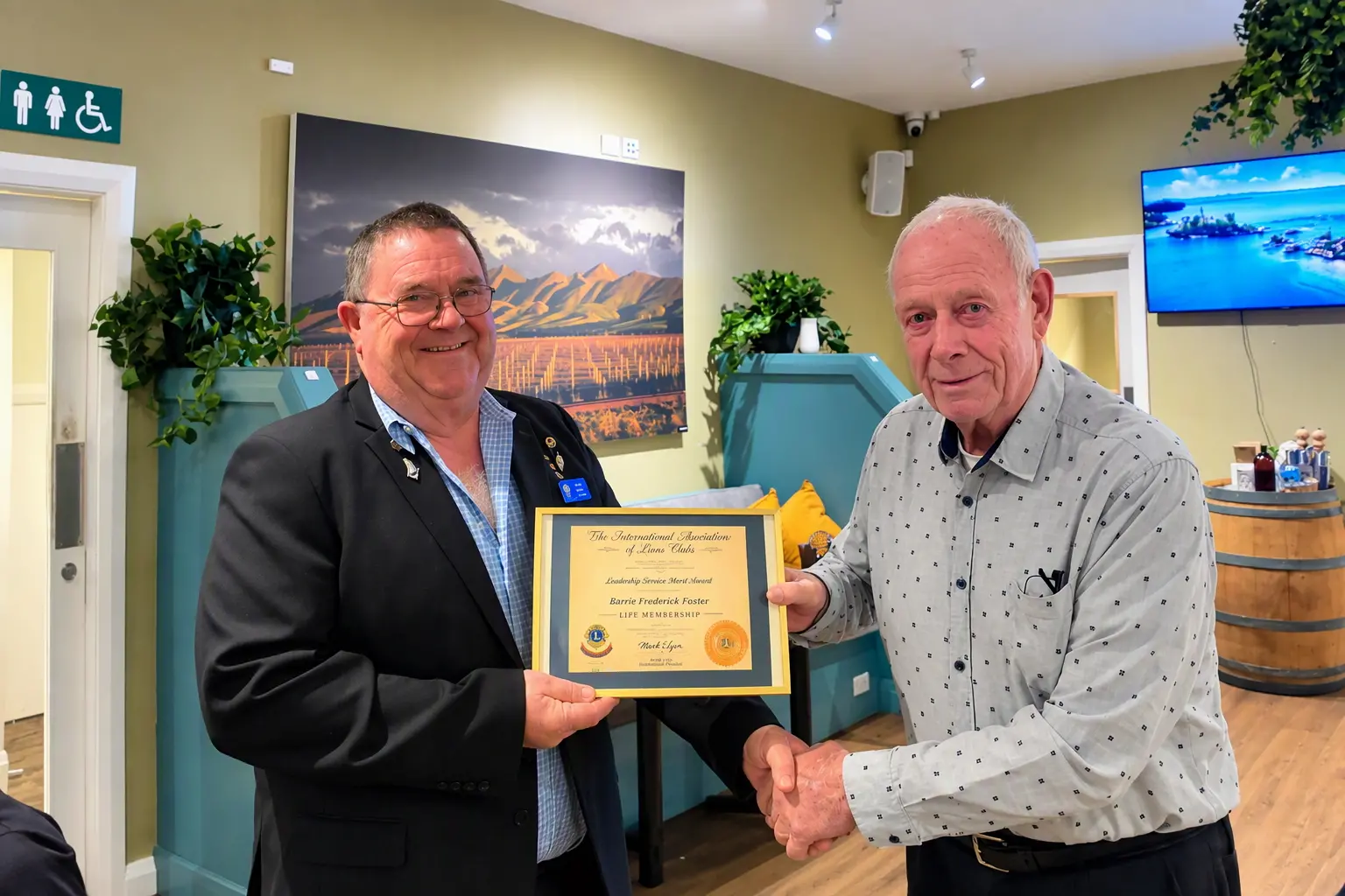 Life membership . . . Barry Foster, an Amberley Lions founding member, being presented with his Life Membership Award by Lion Dave Moore (left). Photo:: Supplied