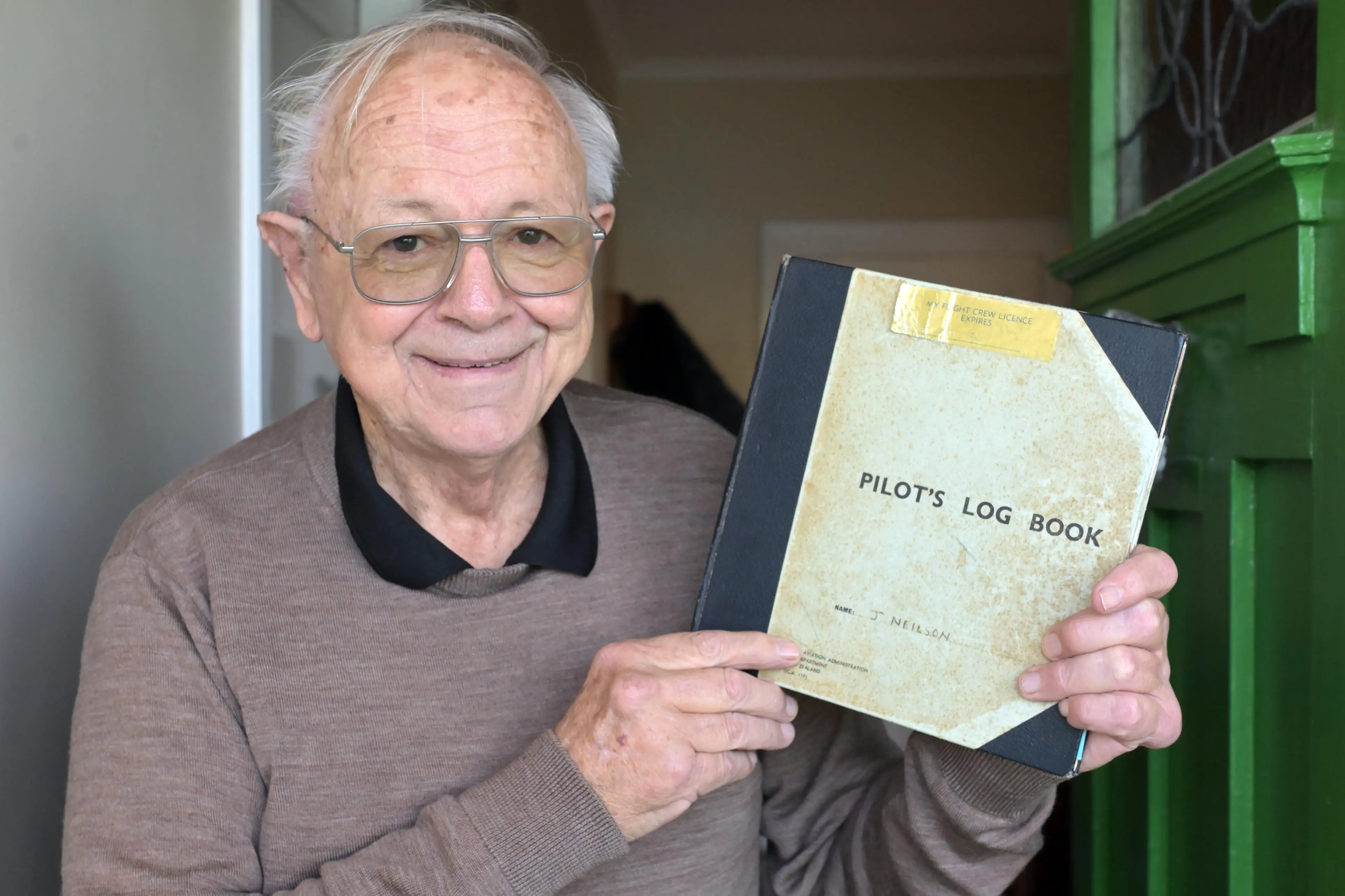 Dunedin man John Neilson holds his pilot\\'s log book. Photo: Gerard O\\'Brien
