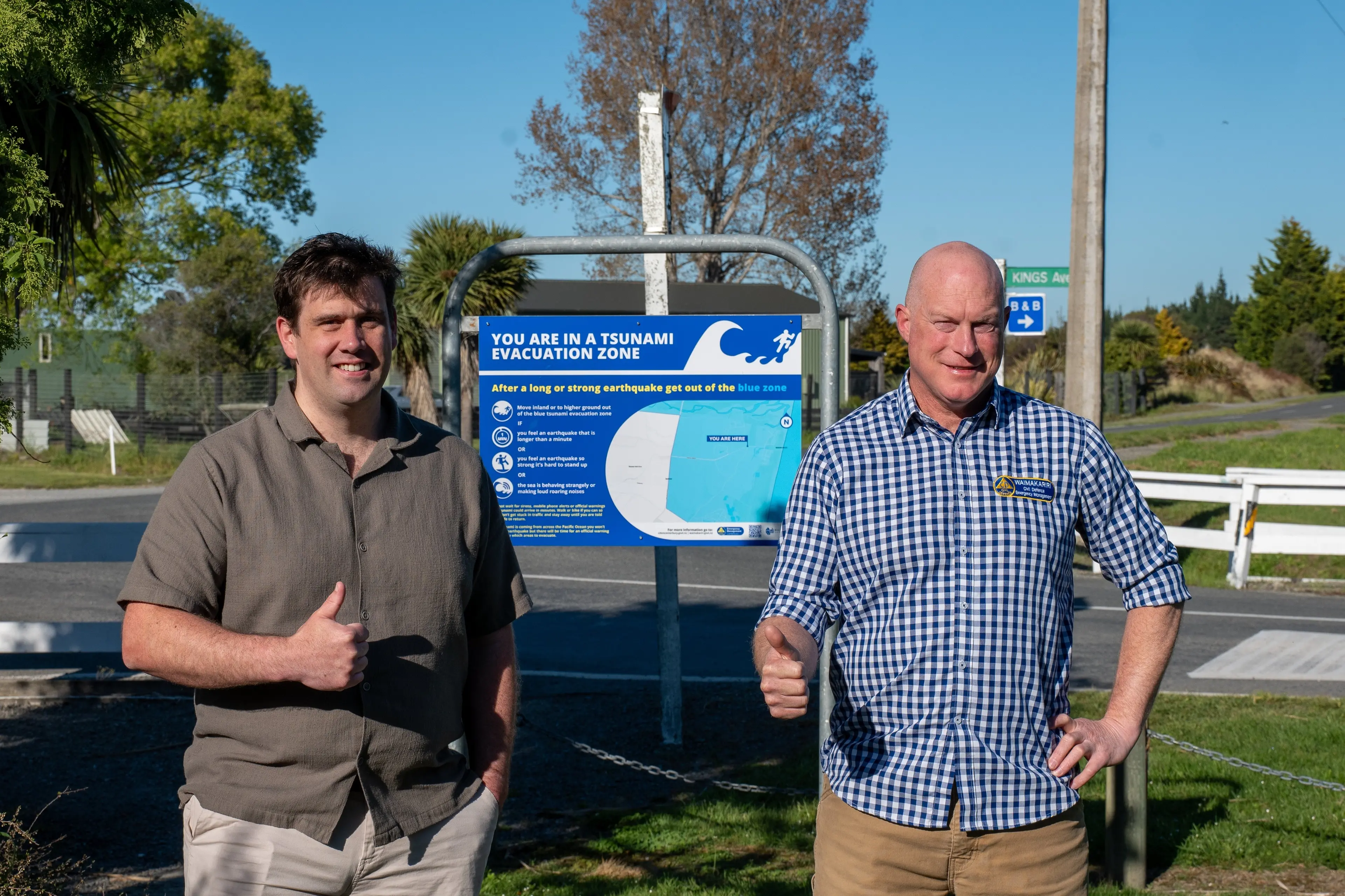 Thumbs up . . . Waimakariri district councillor Jason Goldsworthy (left) and the council\\'s emergency management advisor Dean Eades give the thumbs to the new blue tsunami evacuation zone signs in Waikuku Beach. Photo: Supplied by Waimakariri District Council