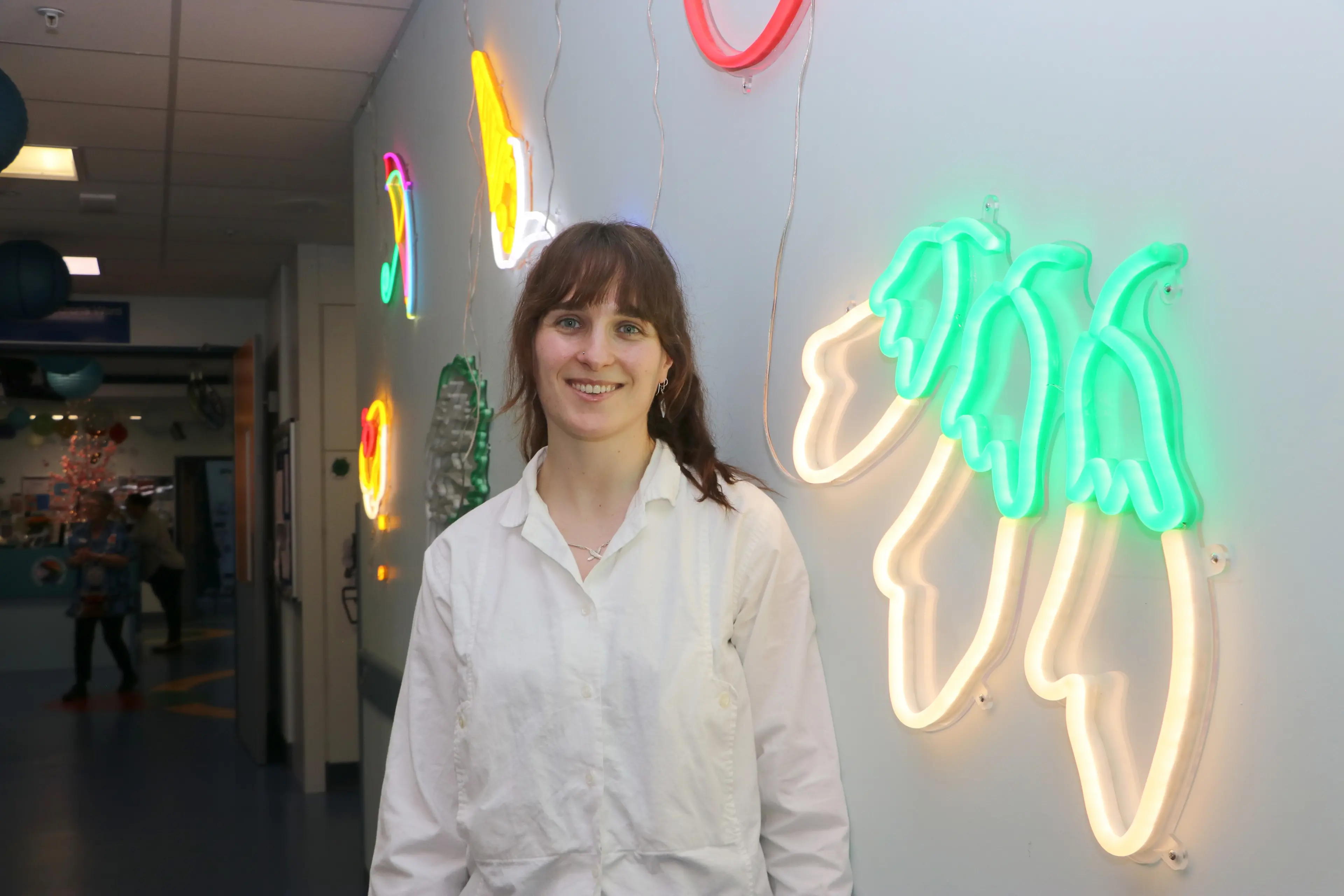He Waka Tuia outreach curator Saskia Whall with artworks by Electric Confetti, which have been installed at the children\\u2019s ward at Southland Hospital in Invercargill. Photo: Invercargill City Council