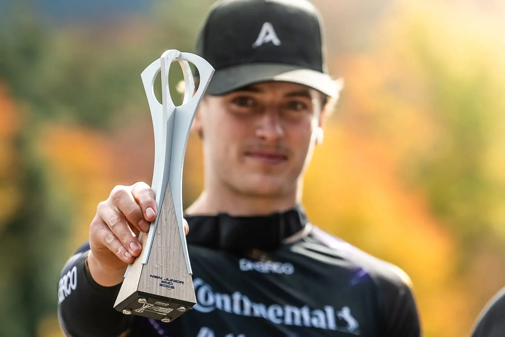 Second in the world: Queenstowner Malik Boatwright\\'s pictured with his trophy after coming second in the 2026 Junior Men\\'s UCI Downhill World Cup last week. Photo: Nathan Hughes