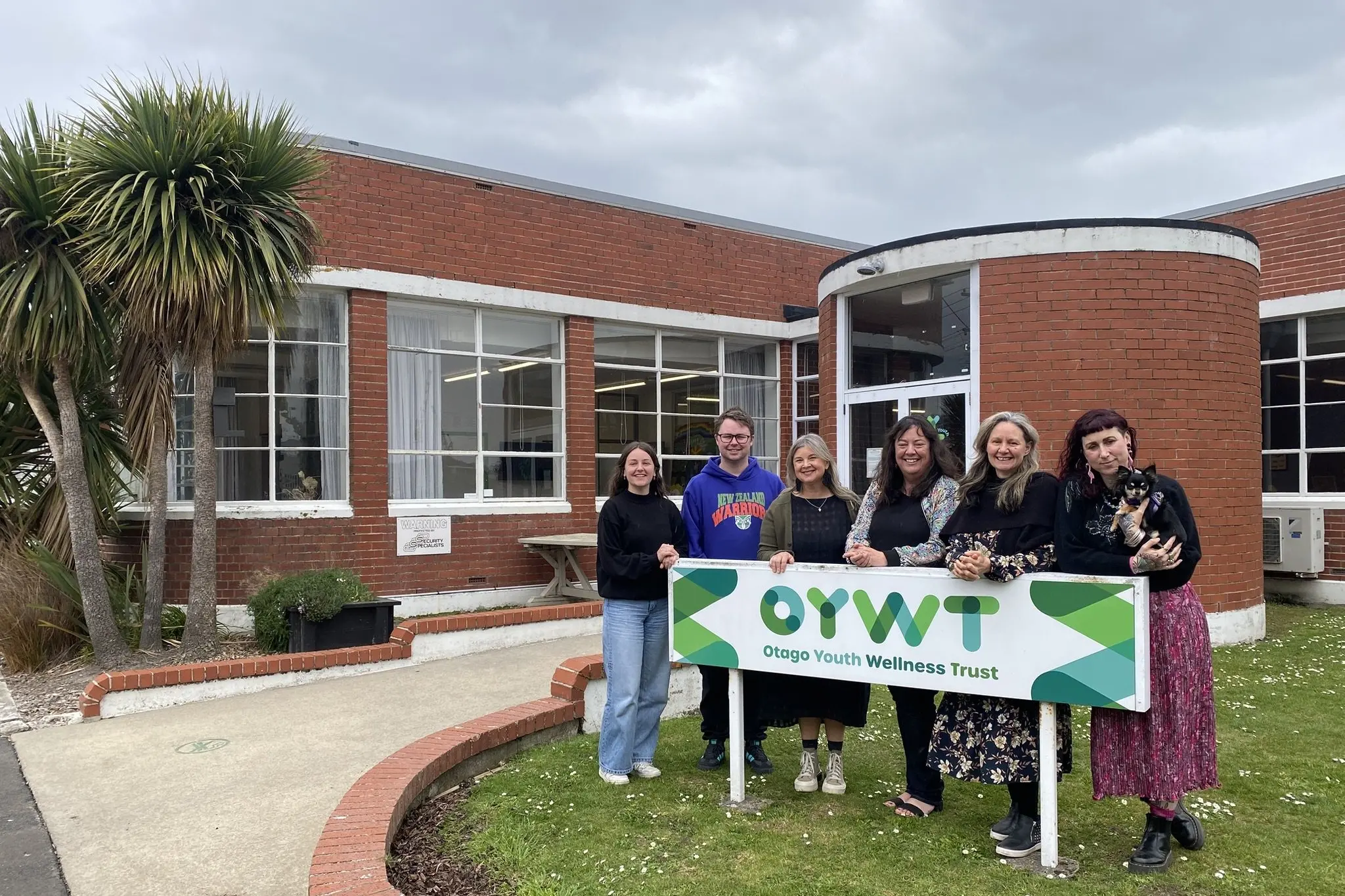 Otago Youth Wellness Trust team members (from left) social work student Olivia Rosenbrock, youth worker Jakob Eder, case worker Gepke Scouten, chief executive Carmen Batchelor, case worker Anita Mitchell, team leader Bree Sapwell (with dog Edie) are looking forward to welcoming the community to next week\\'s 30th anniversary celebrations. Photo: Brenda Harwood