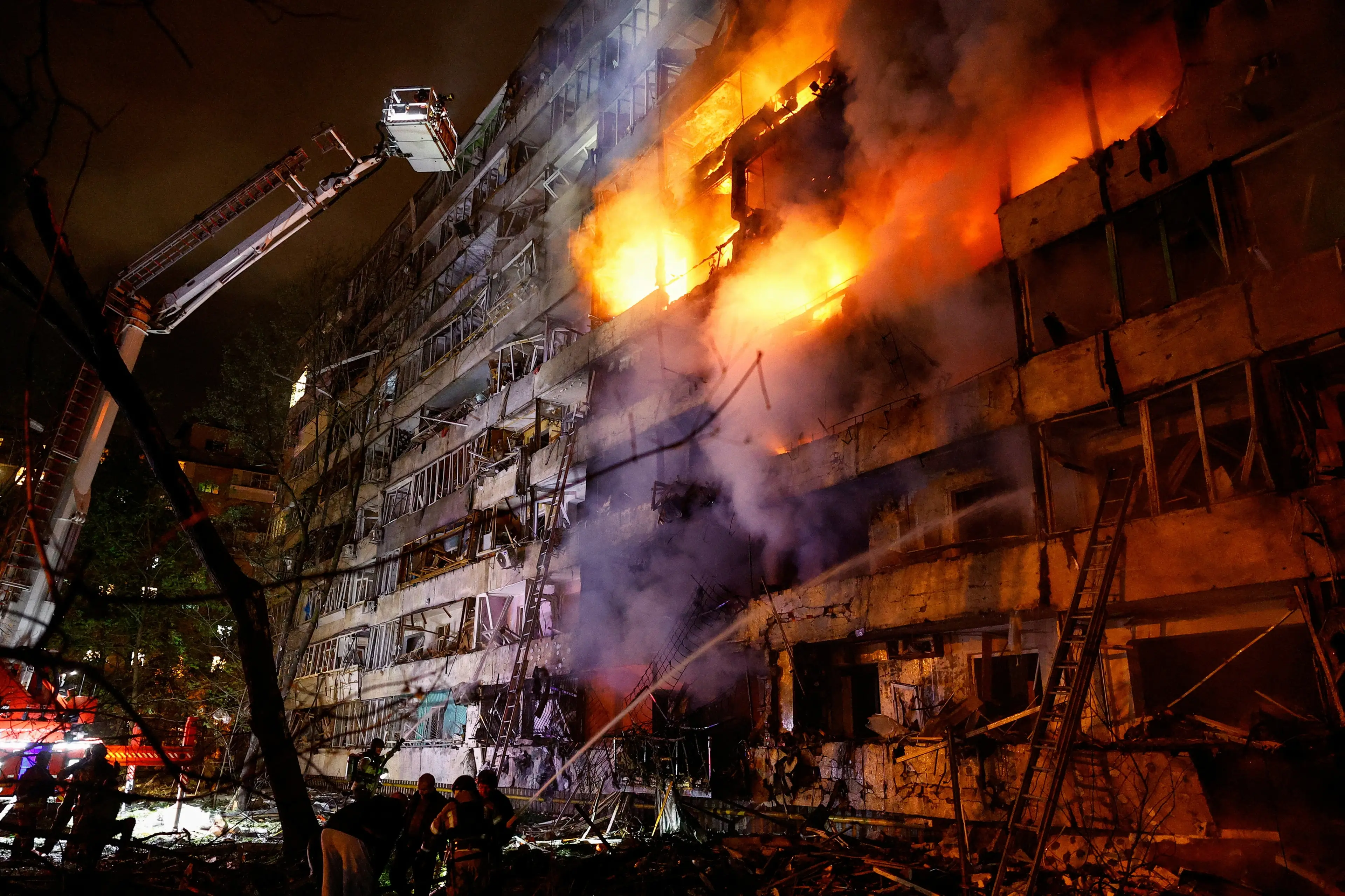Firefighters work at the site of an apartment building damaged by Tuesday\\'s Russian missile strike in Kyiv. Photo: Reuters
