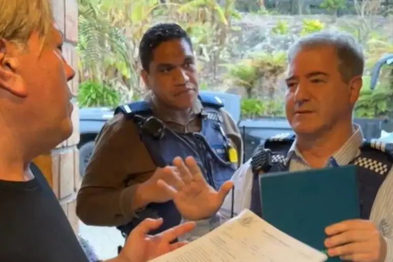 Police serve Destiny Church leader Brian Tamaki a court summons on Thursday. Photo: Screenshot / Facebook