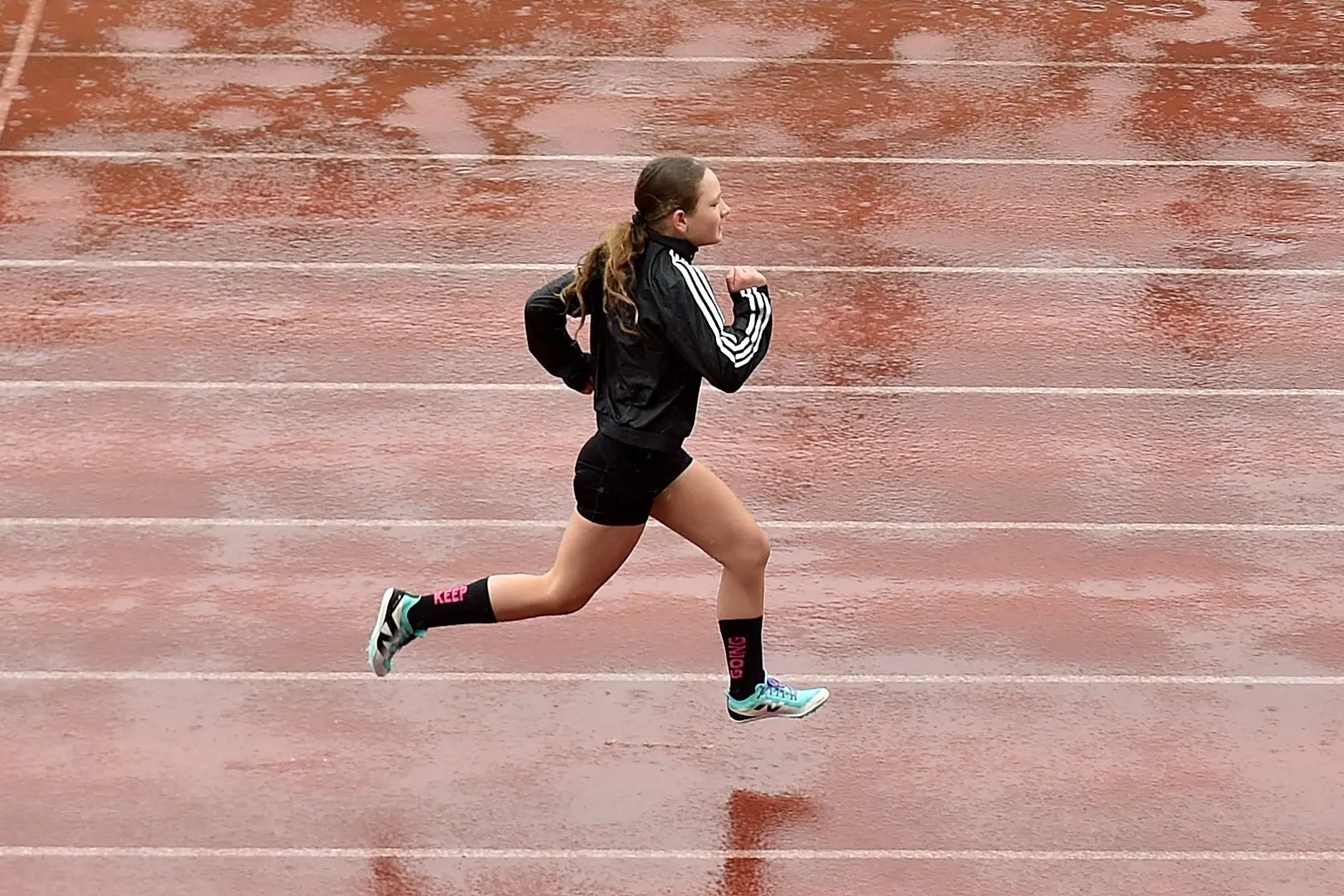 Mckenzie Wallace, 11, of Tapanui, trains on a wet Caledonian Ground in Dunedin on Thursday. The athletics track is soon to be resurfaced. Photo: Peter McIntosh