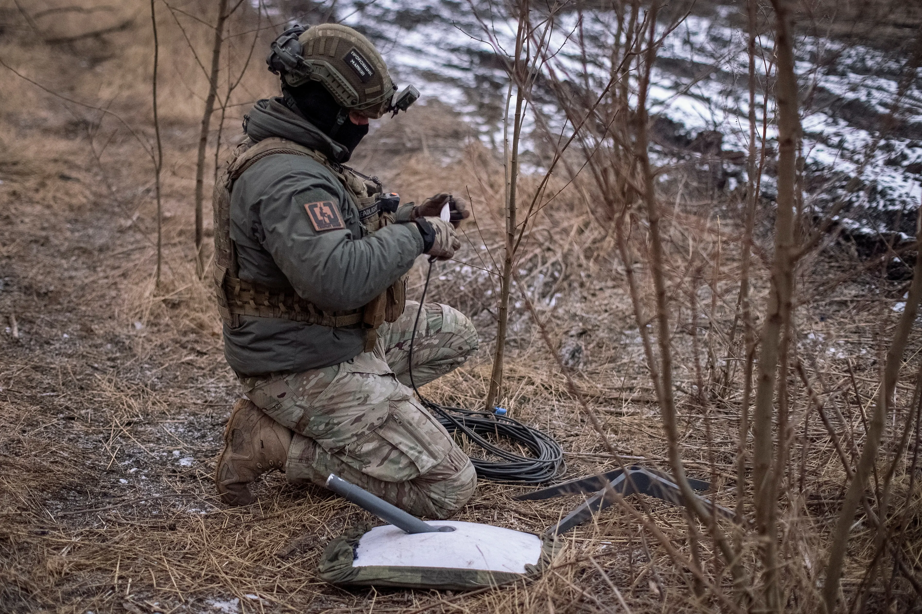 A Ukrainian serviceman prepares a Starlink satellite internet system near the town of Avdiivka, in the Donetsk region. File photo: Reuters