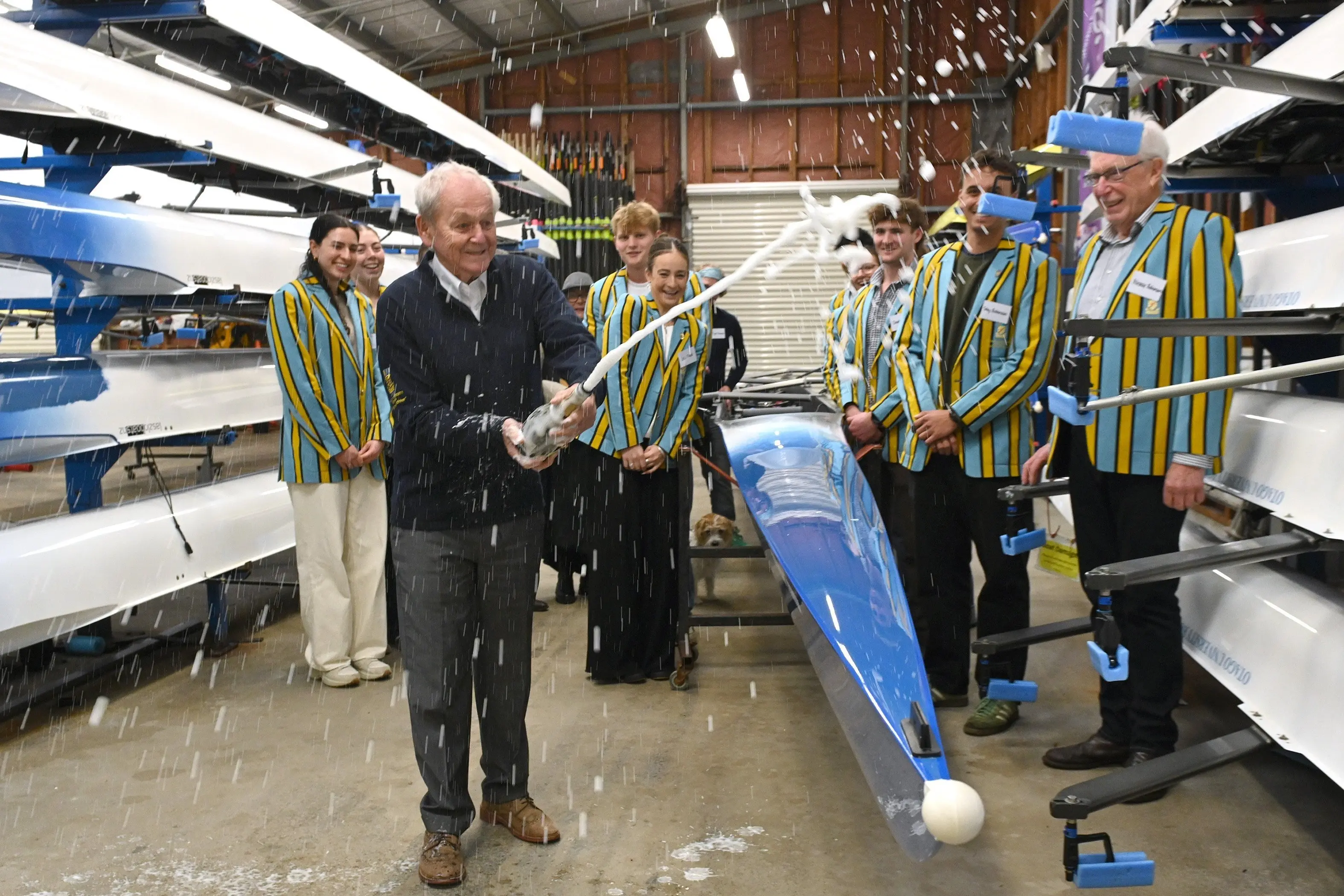 Sir Murray Brennan pops some champagne to celebrate the new Otago University Rowing Club boat named in his honour. Photo: Linda Robertson