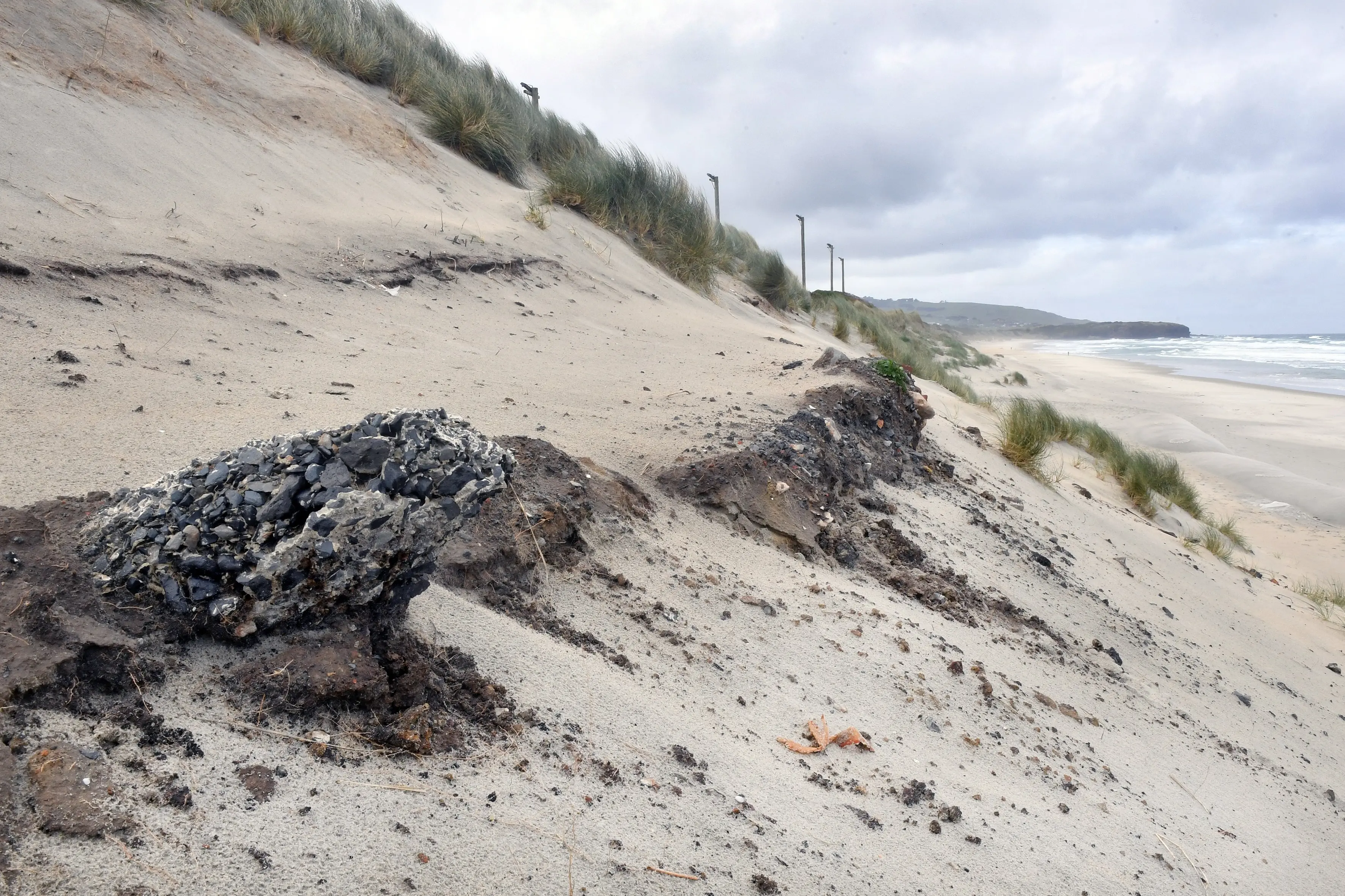 Rubble is exposed in the sand dunes above Middle Beach, St Kilda. Photo: Stephen Jaquiery