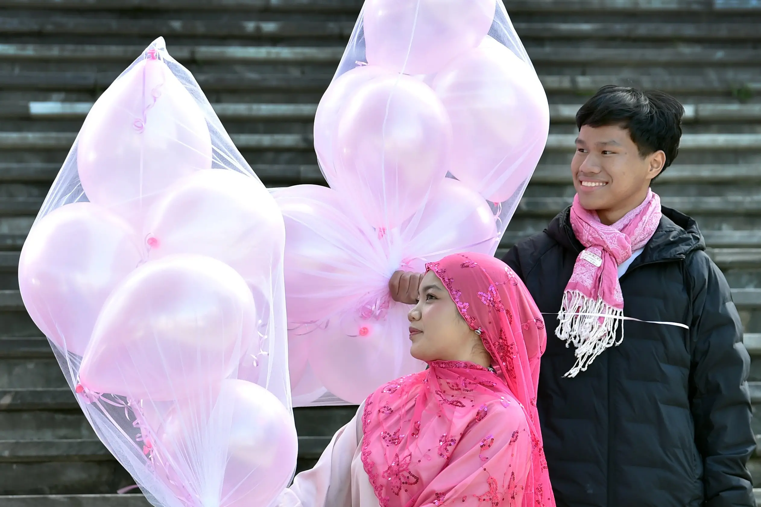 Anniesa Daniel and Arash Rahim, both 20, hand out balloons in the Octagon on Friday to raise awareness of breast cancer as part of the Breast Cancer Foundation NZ\\'s Pink Ribbon Street Appeal. Photo: Peter McIntosh