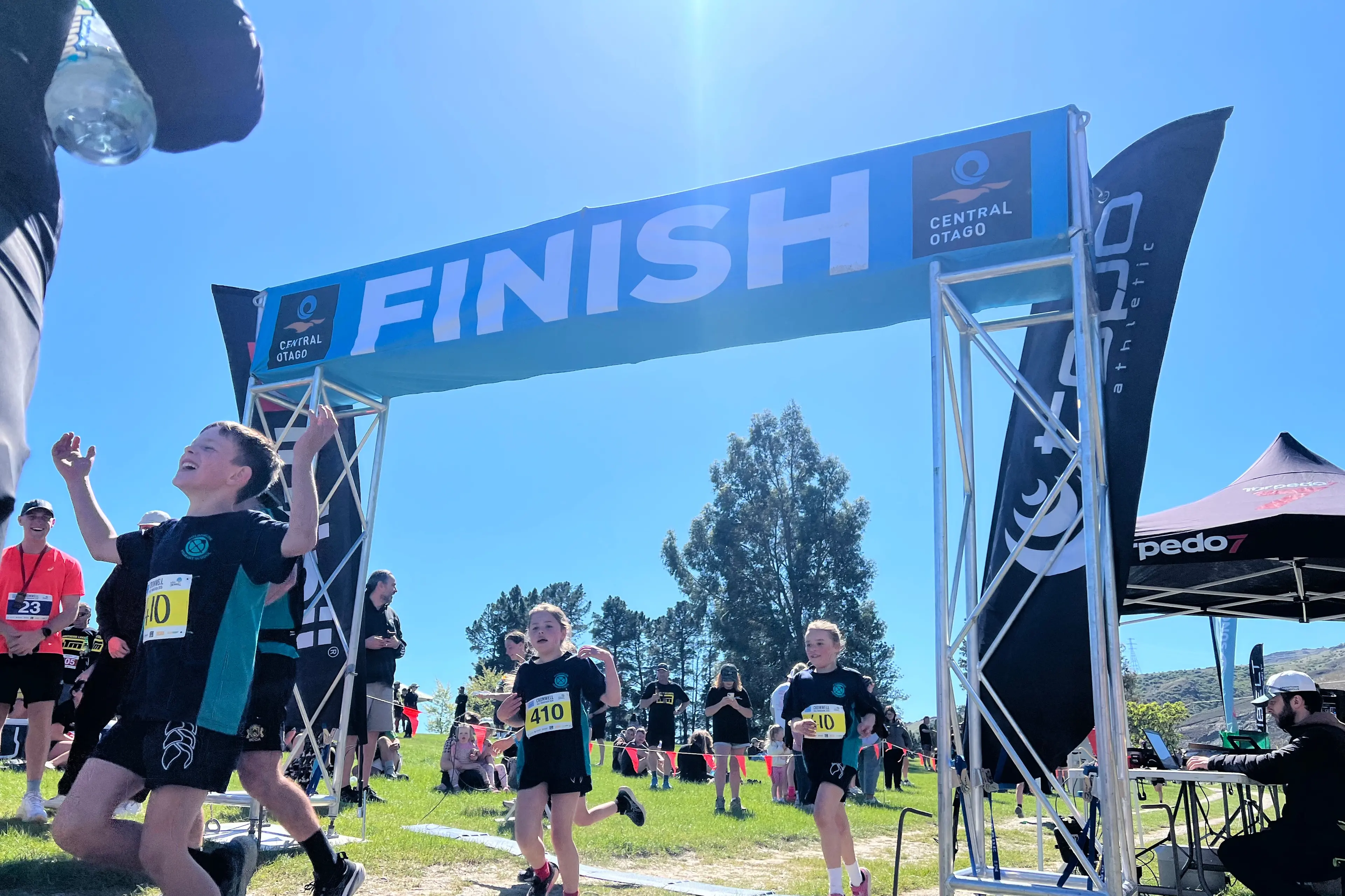 Goldfields Primary School students cross the finish line after competing in the relay division of the half marathon. Photo: Carys Trotter