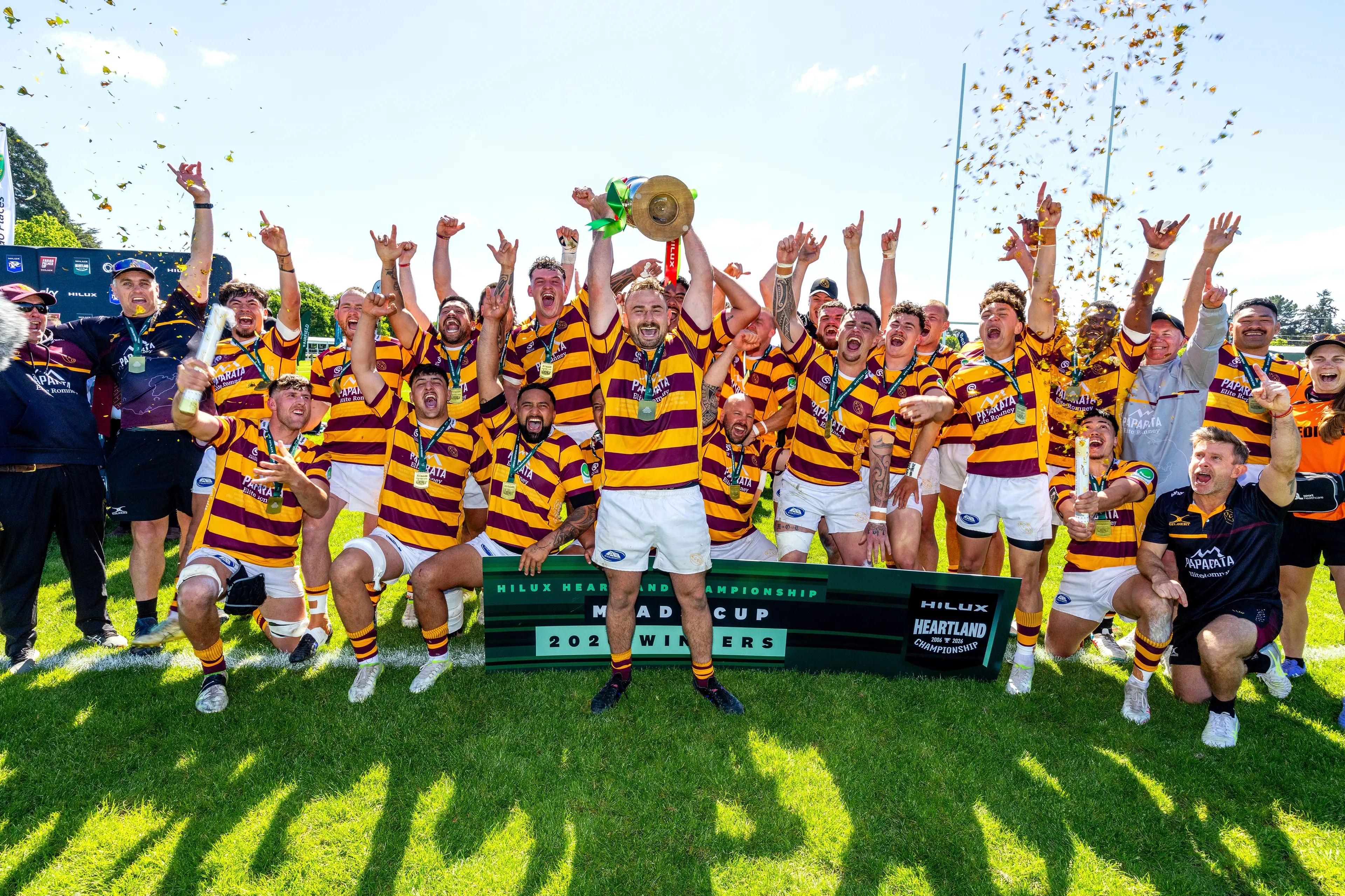 King Country captain Liam Rowlands lifts the Meads Cup in front of his celebrating team-mates after their win over Mid Canterbury in the final at the Ashburton Showgrounds on Saturday. Photo: NZ Rugby/alphapix