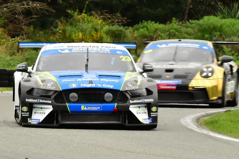 Jordan Michels, of Invercargill, winner of Class 1 in the South Island Endurance 1 Hour Series in his Marc Mustang leads the Steve Brooks/Hugo Allan Porsche at Teretonga Park in Invercargill on Saturday. Photo: Dave Loudon