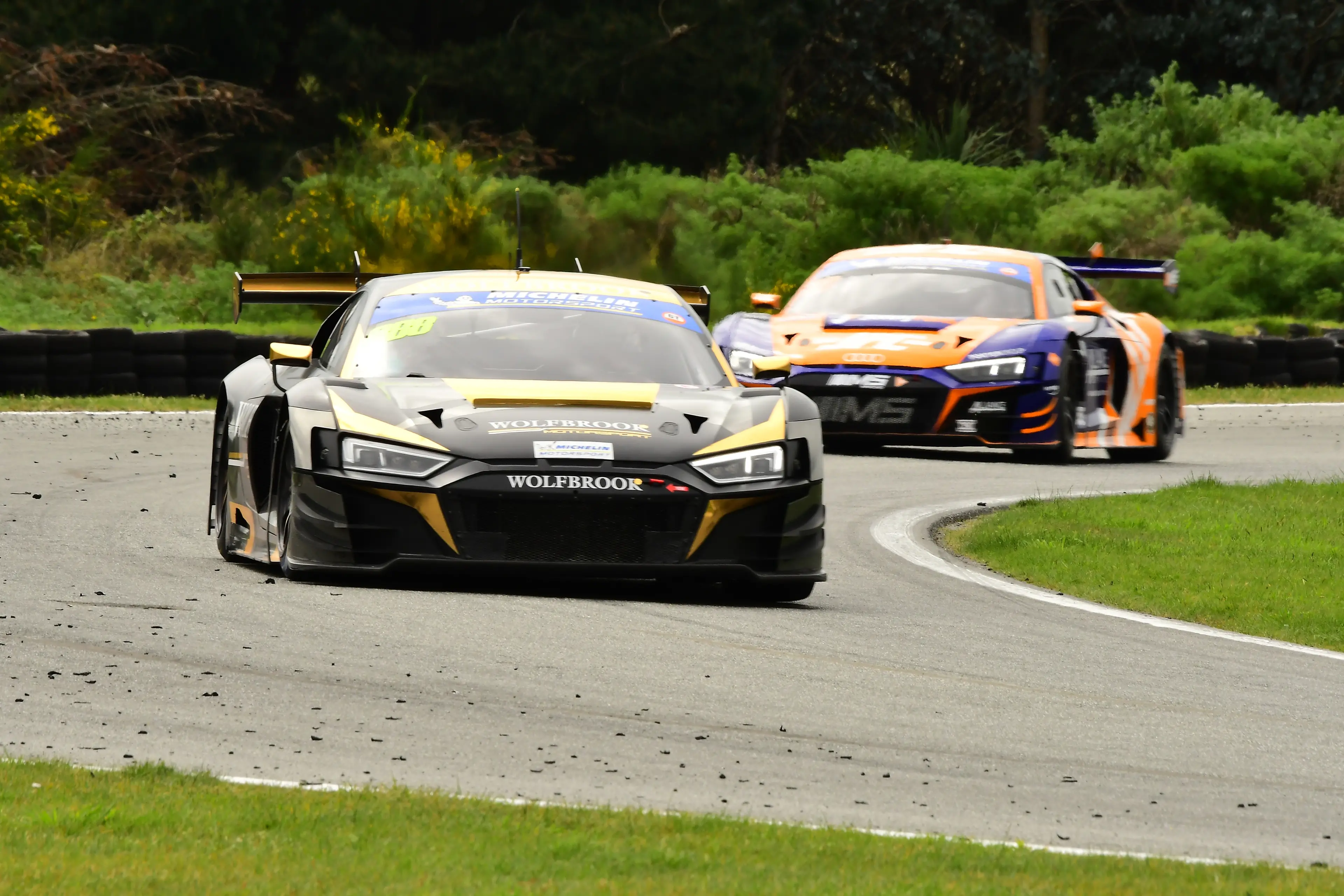 Steve Brooks and Willie Exton lead their Audi R8 LMS Evo 2 through the loop at Teretonga Park ahead of another Audi, driven by Sam Fillmore and Jonny Reid, during the three-hour race on Saturday. Photo: Dave Loudon