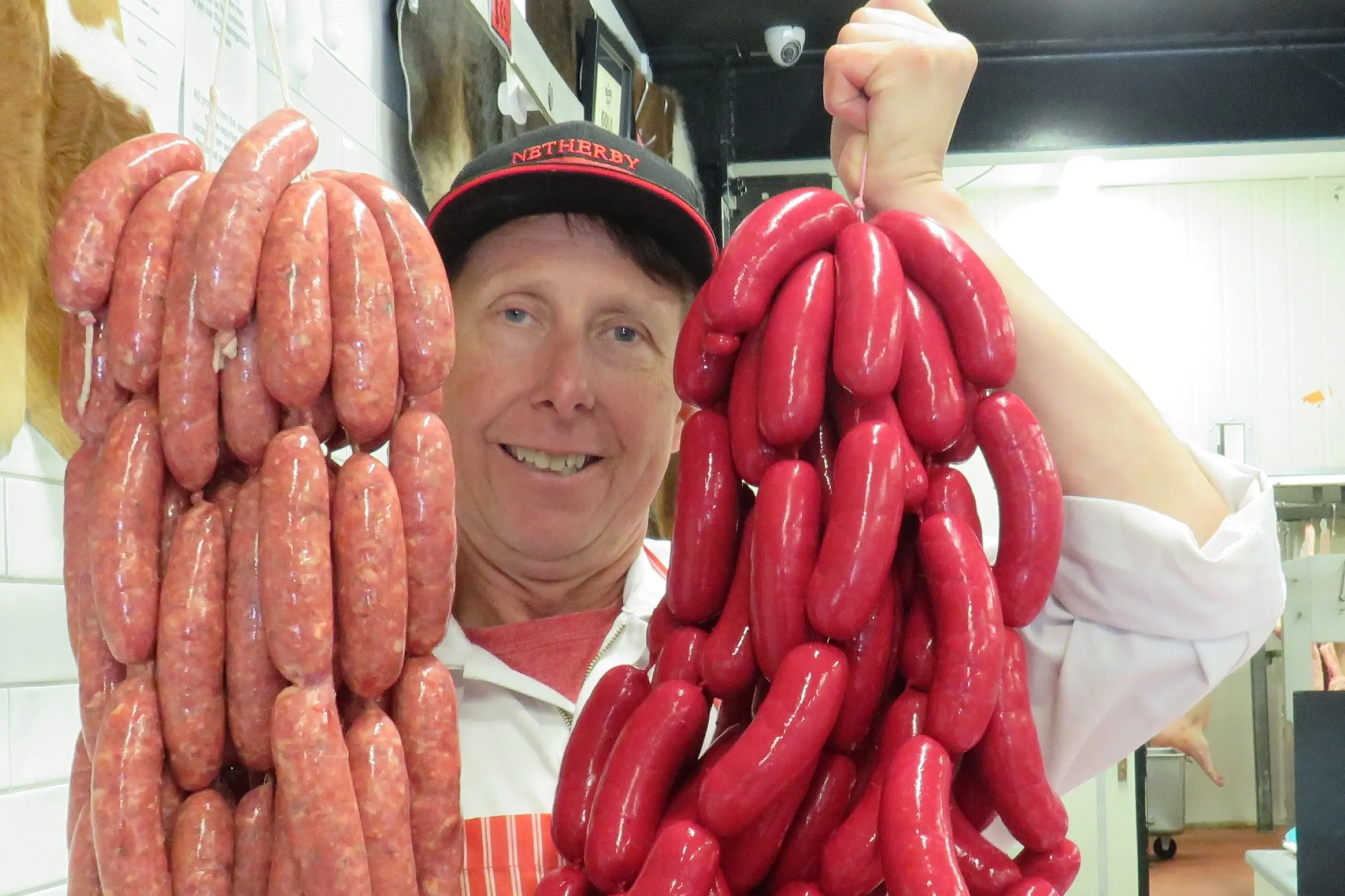 Co-owner of the Netherby Meats Mick Hanson with their award winning cheeseburger sausages and traditional saveloys.  Photo: Dellwyn Moylan