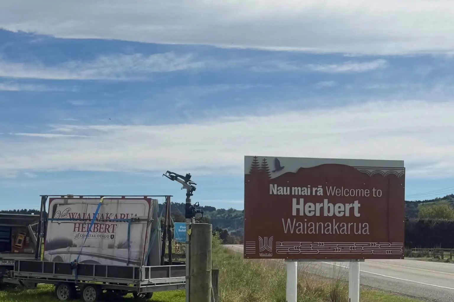 The old Herbert and Wainakarua sign is taken away as the new sign goes up. Photo: Chris Manson