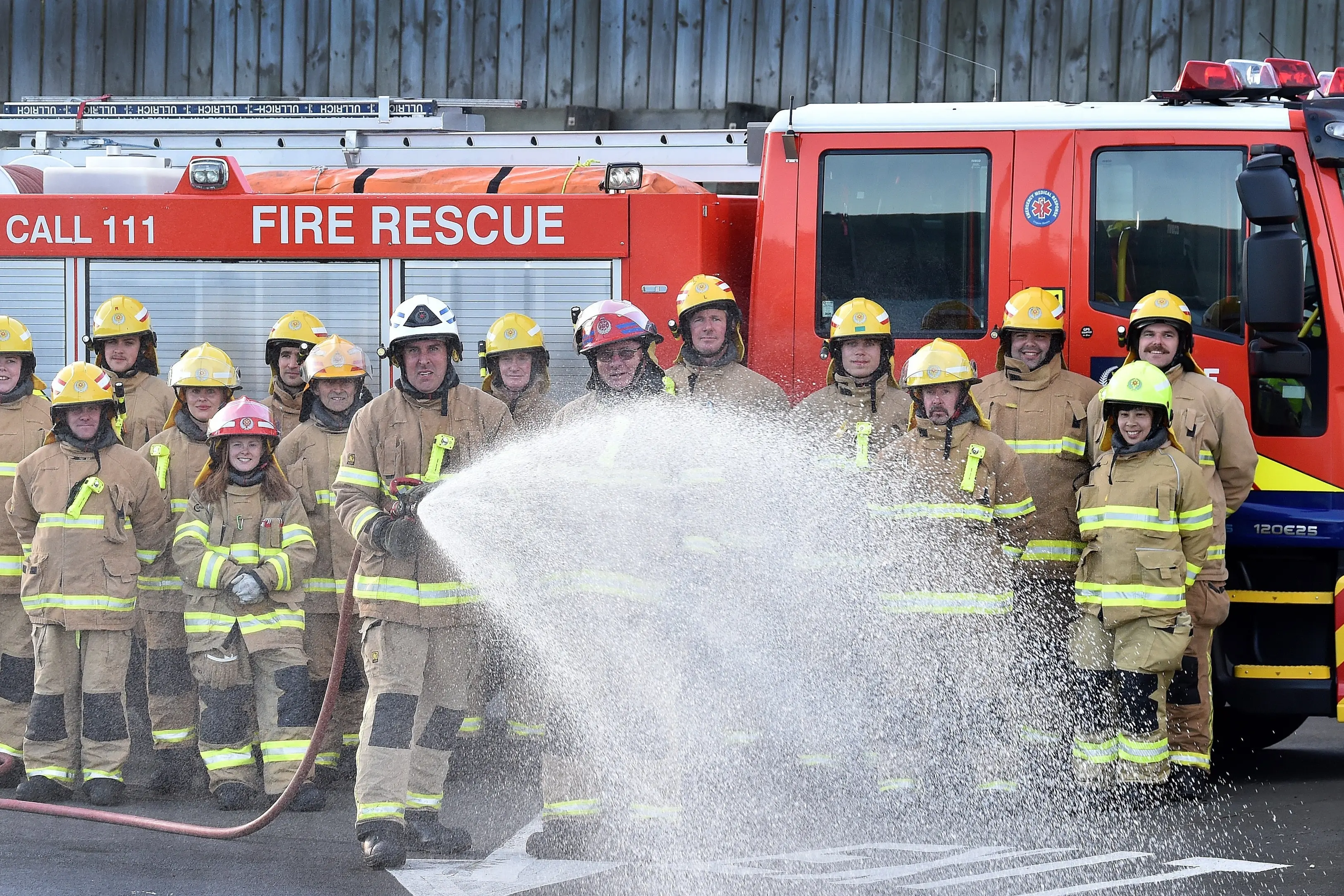 Ravensbourne Fire Brigade chief fire officer (front left) Jason Bryant and senior station officer Ross Bryant (front right) with the rest of the Ravensbourne Volunteer Fire Brigade, who are preparing to celebrate the brigade\\'s 100th anniversary on Saturday. Photo: Peter McIntosh