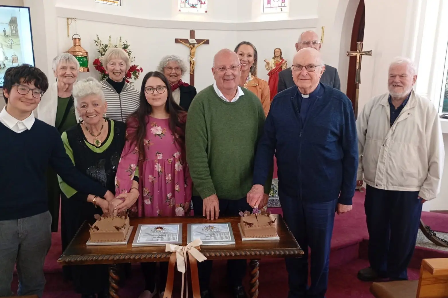 The unveiling of the extraordinary research done by Port Chalmers woman Carol Meikle into the life and Port Chalmers connections of St Mary MacKillop was celebrated on Saturday at St Mary Star of the Sea Church. Pictured during the cake cutting were (back, from left) Yvonne Greer, Faye Zorgie, Pauline Medder, Georgina Meikle, Bishop Michael Dooley, Fr Peter Norris, (front, from left) Matthew Suwanarusk,Carol Meikle QSM, Mina Suwanarusk, Fr Mark Chamberlain, and\\nFr Aidan Cunningham. Photo: Supplied